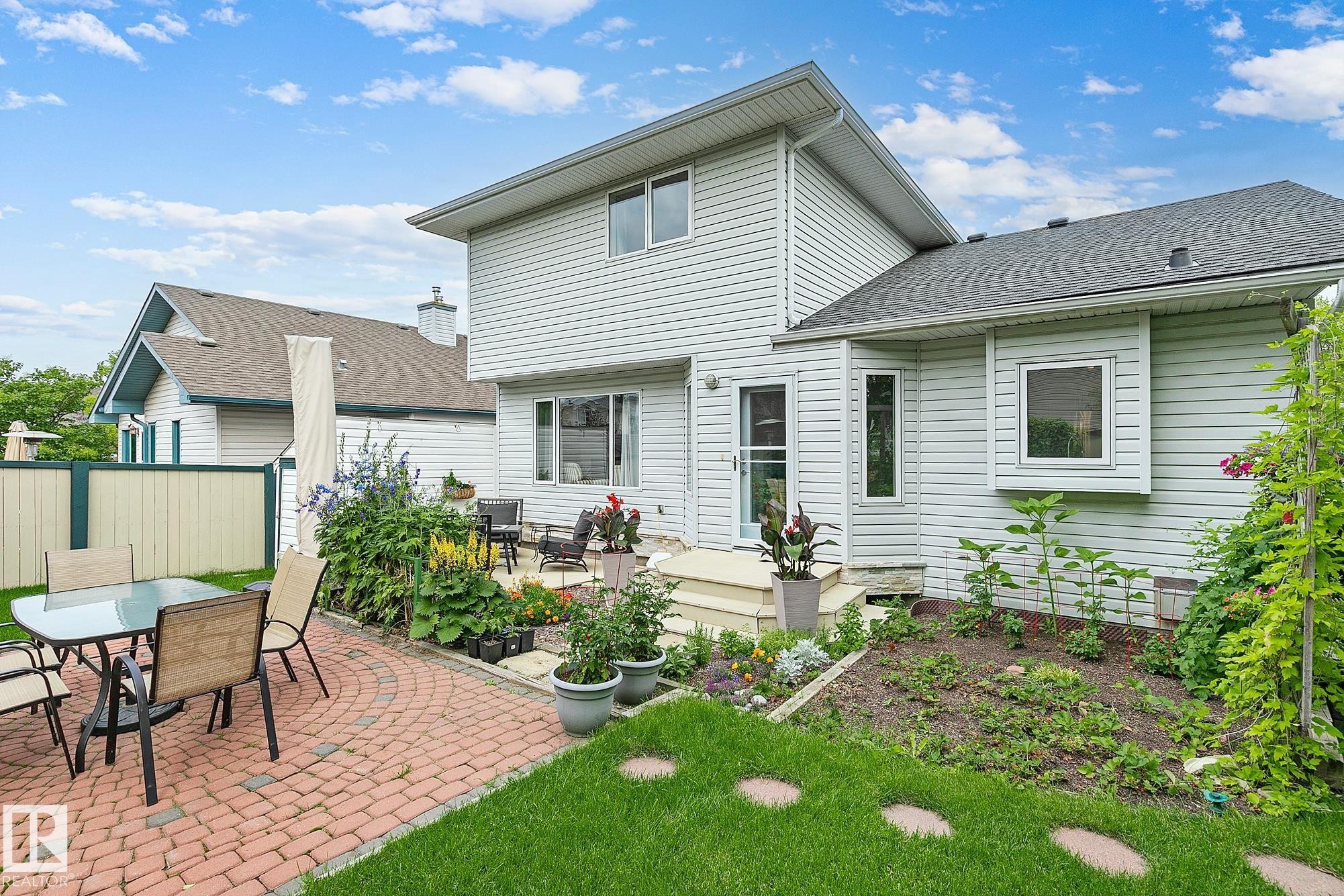 Expansive backyard featuring a red brick paver patio and a separate deck - 385 Meadowview Terrace, Sherwood Park, AB - Outdoor With Deck Patio Veranda With Exterior