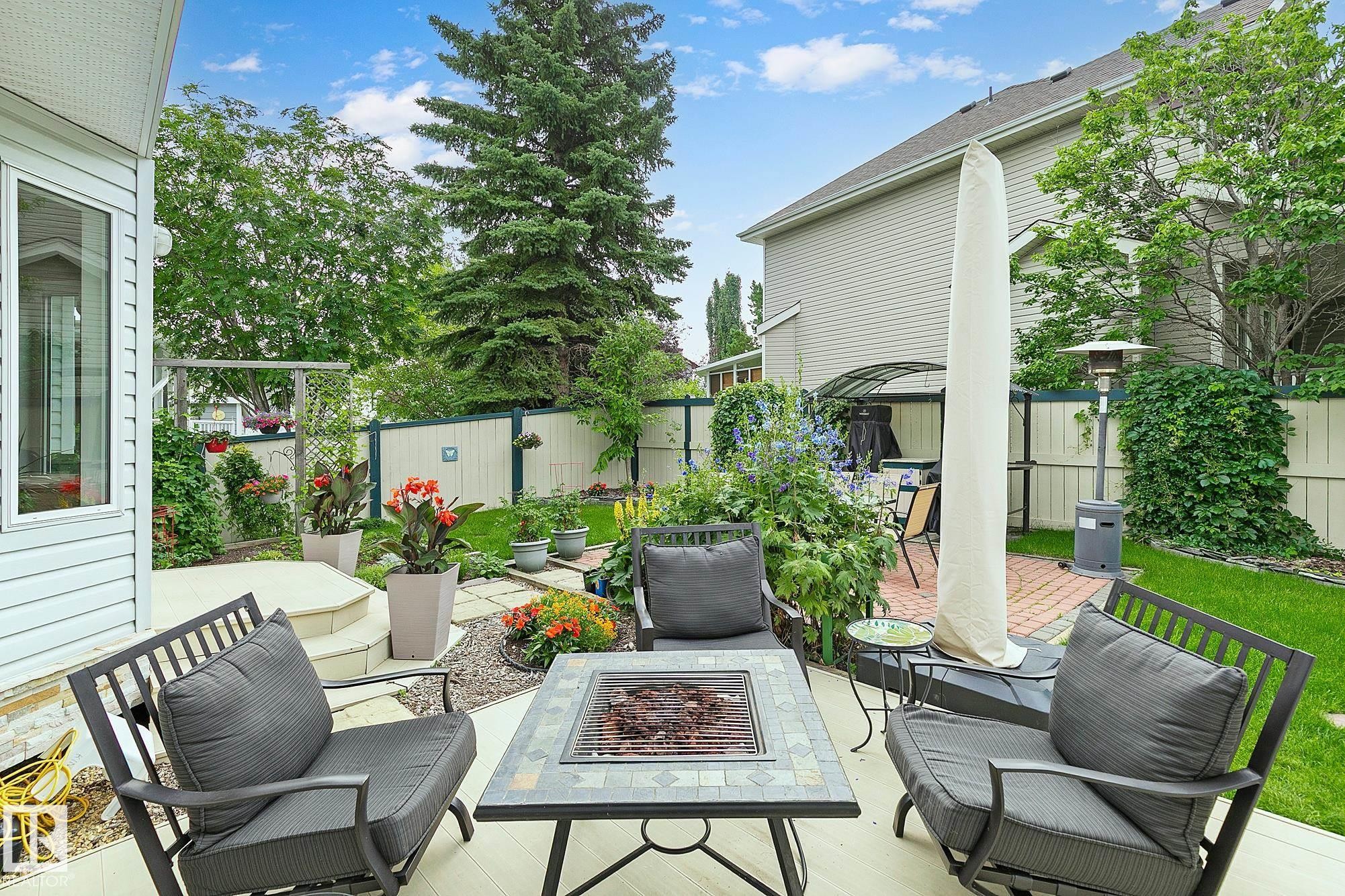 Gorgeous outdoor space includes a deck and a separate patio with a fire pit - 385 Meadowview Terrace, Sherwood Park, AB - Outdoor With Deck Patio Veranda With Exterior