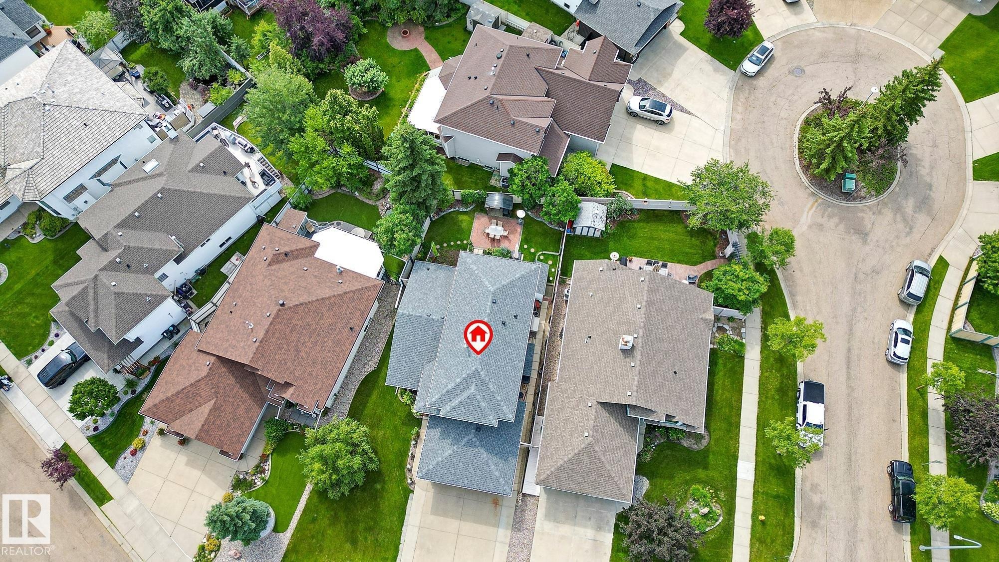 Aerial perspective of a property featuring a gray shingle roof, surrounded by green lawns and mature trees - 385 Meadowview Terrace, Sherwood Park, AB - Outdoor With View