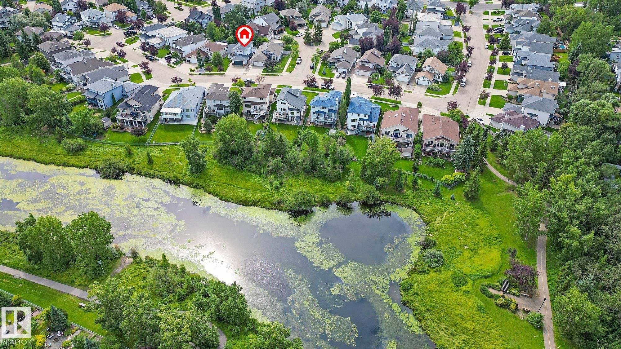 Aerial perspective featuring residential properties bordering a natural water feature and extensive green spaces - 385 Meadowview Terrace, Sherwood Park, AB - Outdoor With View