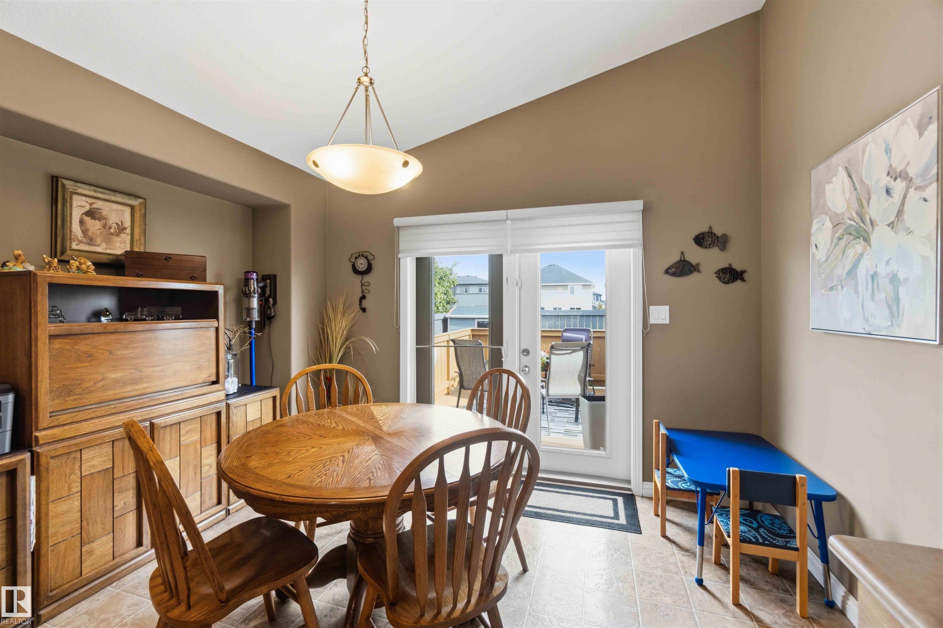 Dining area featuring a vaulted ceiling and tile flooring - 6320 166 Avenue Nw, Edmonton, AB - Indoor Photo Showing Dining Room