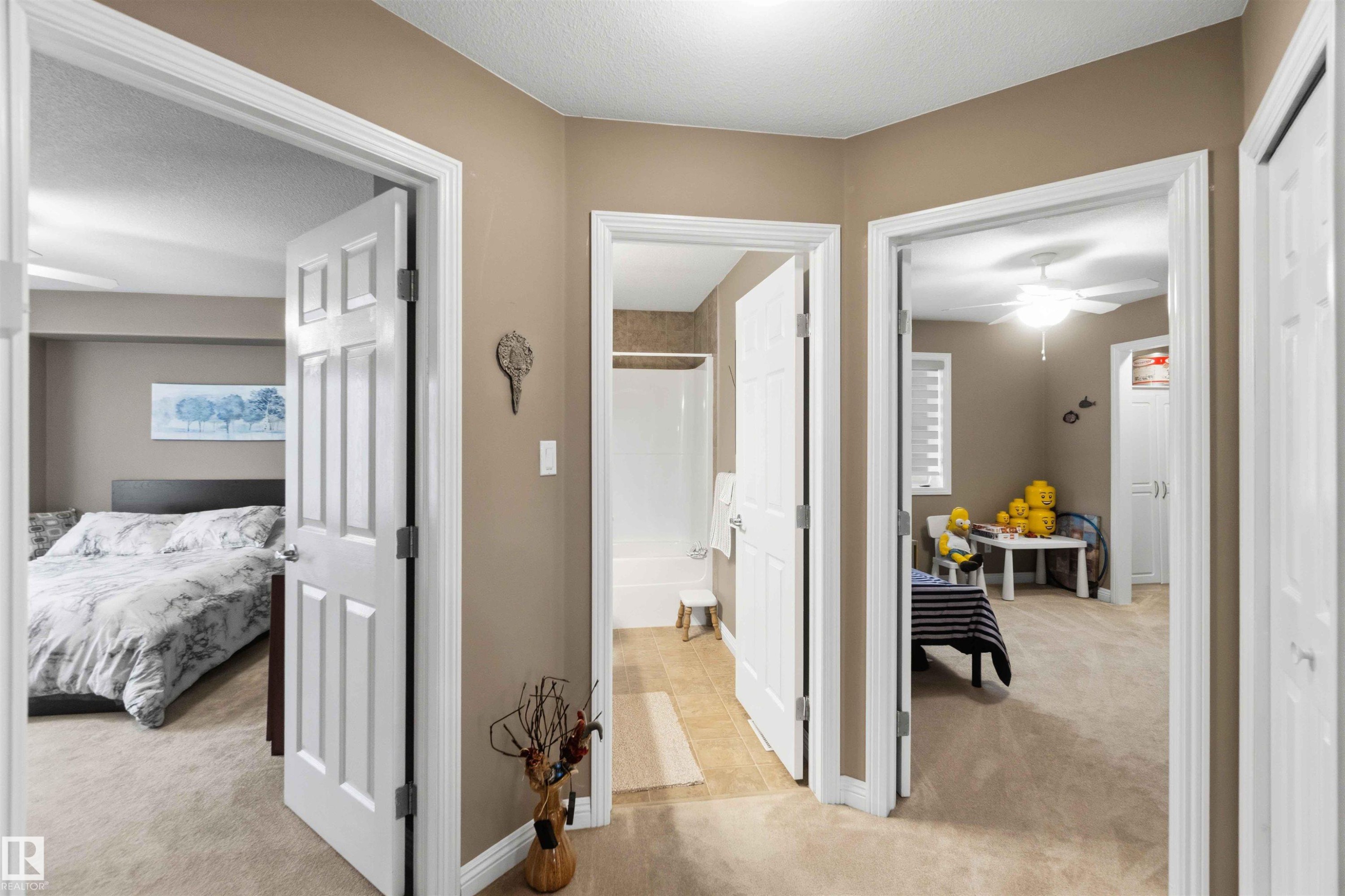 Hallway featuring neutral-toned walls, white trim, and carpeted flooring - 6320 166 Avenue Nw, Edmonton, AB - Indoor Photo Showing Bedroom