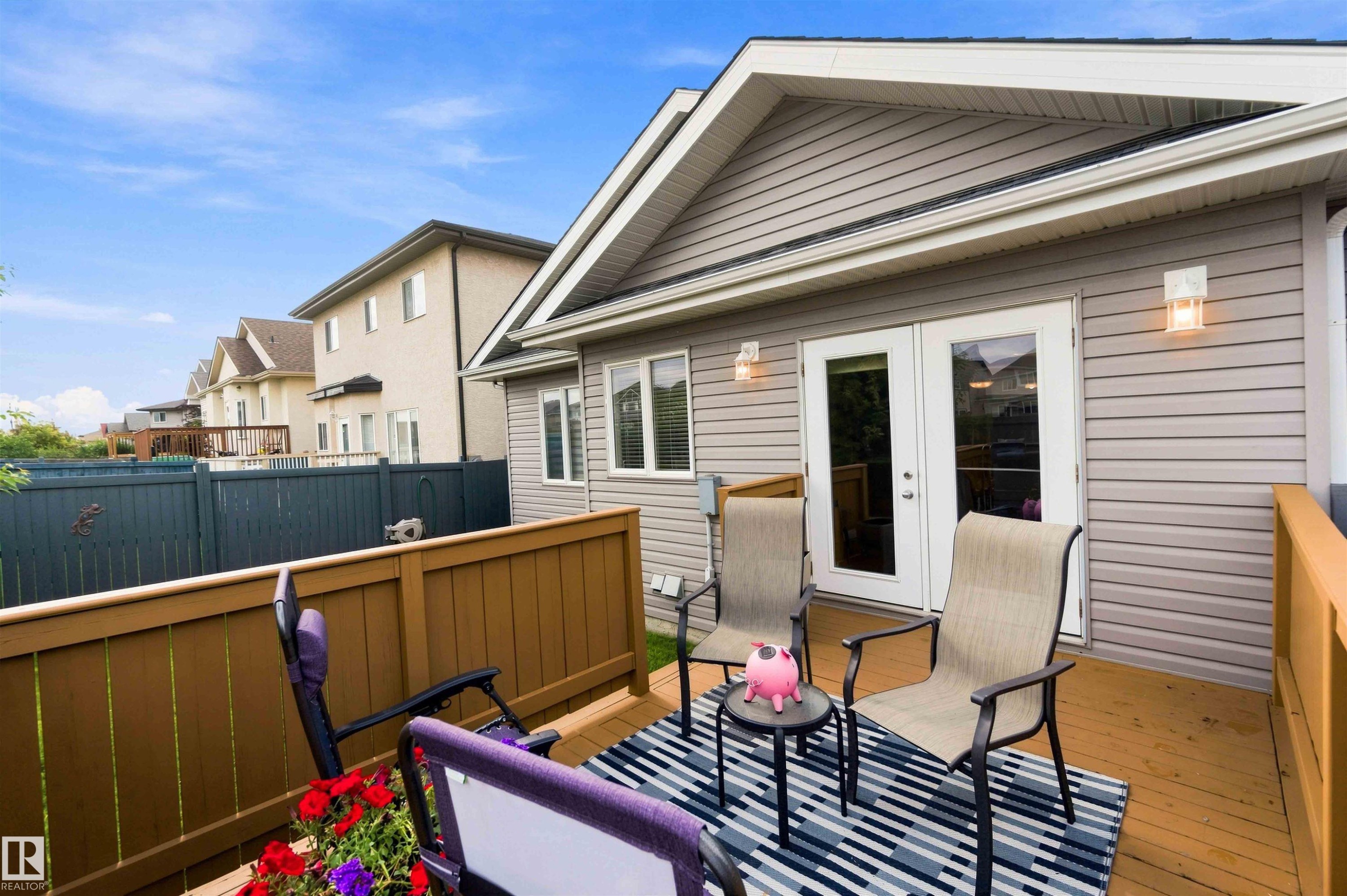 Rear deck with wood-finish flooring and sturdy wood railing - 6320 166 Avenue Nw, Edmonton, AB - Outdoor With Exterior