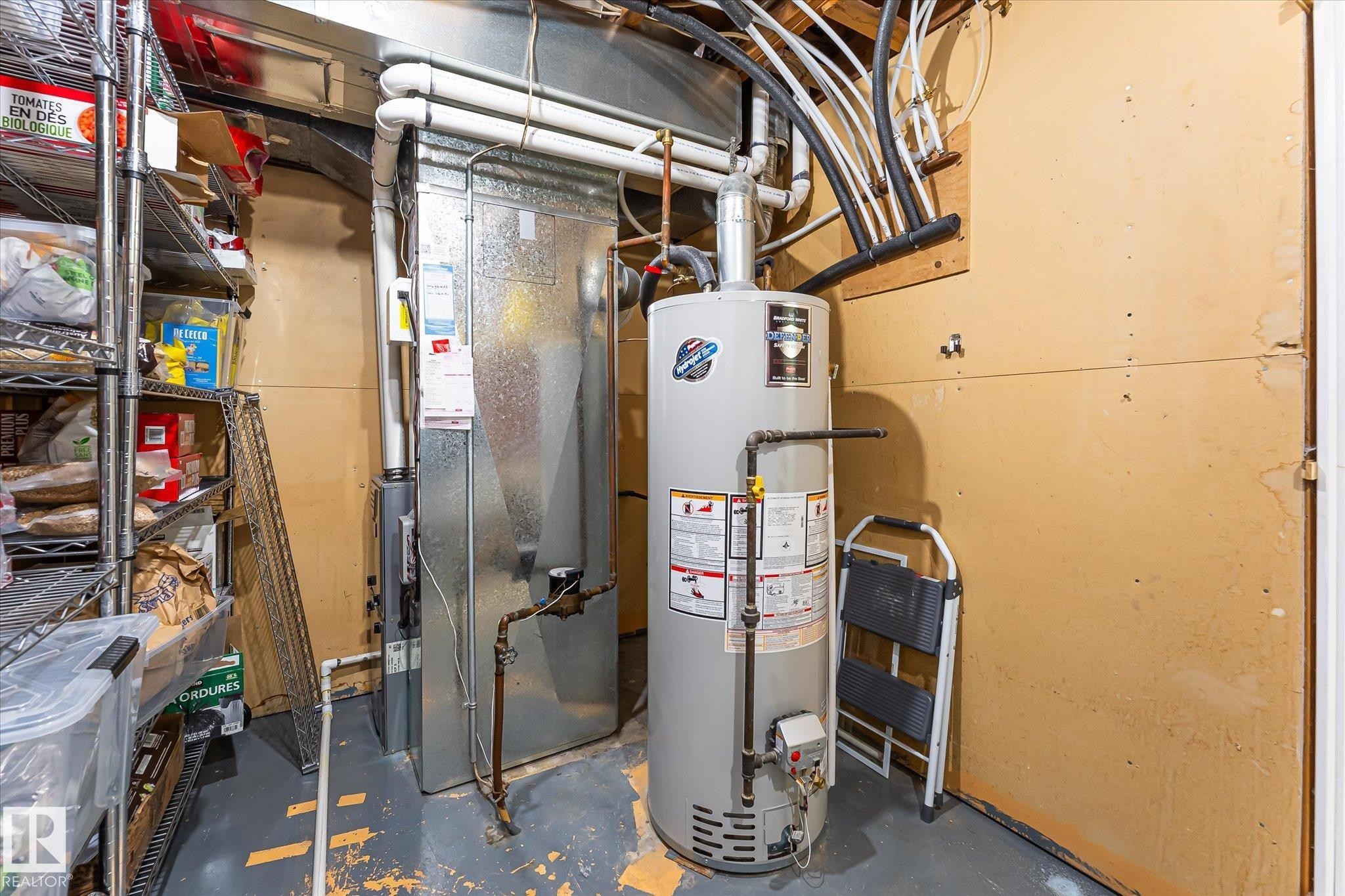 Utility area featuring a water heater and furnace - 4921 47 Avenue, Legal, AB - Indoor Photo Showing Basement