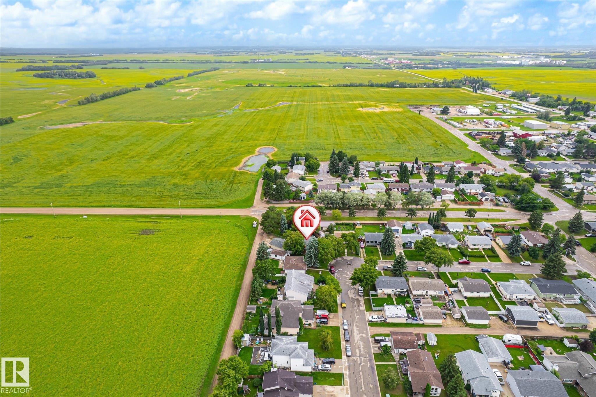 Aerial overview of a residential neighborhood with surrounding green fields - 4921 47 Avenue, Legal, AB - Outdoor With View