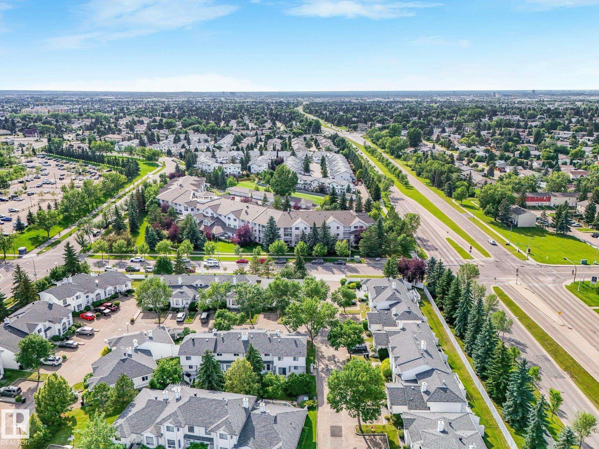 Aerial perspective showcasing the residential community with established landscaping and mature trees - #2 3311 58 St Nw, Edmonton, AB - Outdoor With View
