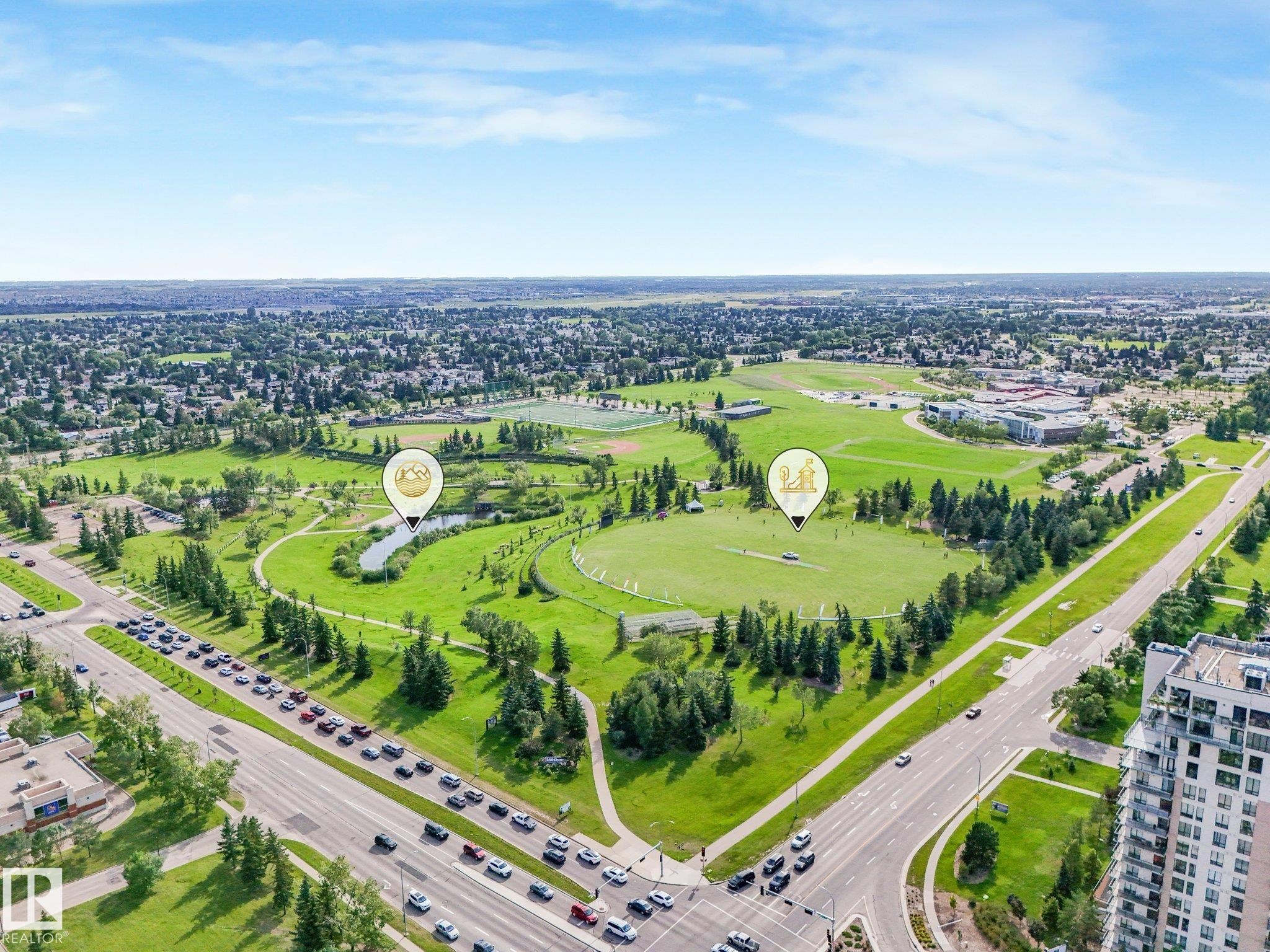 Expansive green spaces featuring walking paths, varied tree coverage, open fields, and a tranquil pond - #2 3311 58 St Nw, Edmonton, AB - Outdoor With View