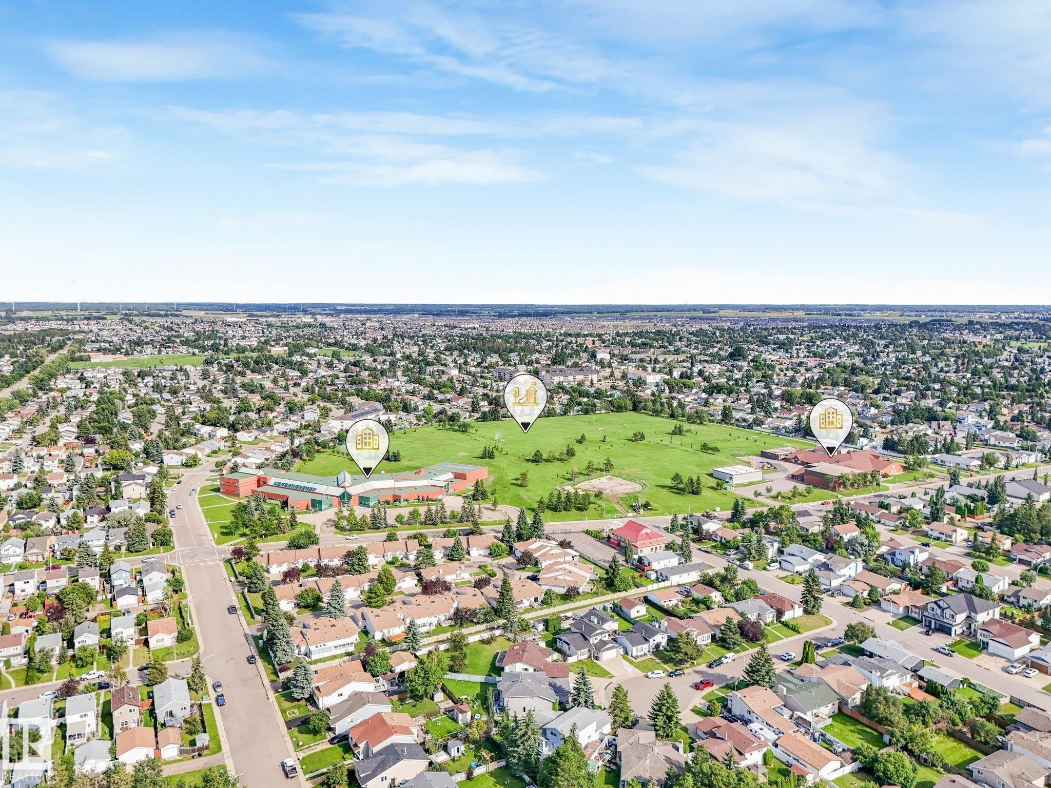 Aerial perspective showcasing a residential area with a prominent green space - #2 3311 58 St Nw, Edmonton, AB - Outdoor With View