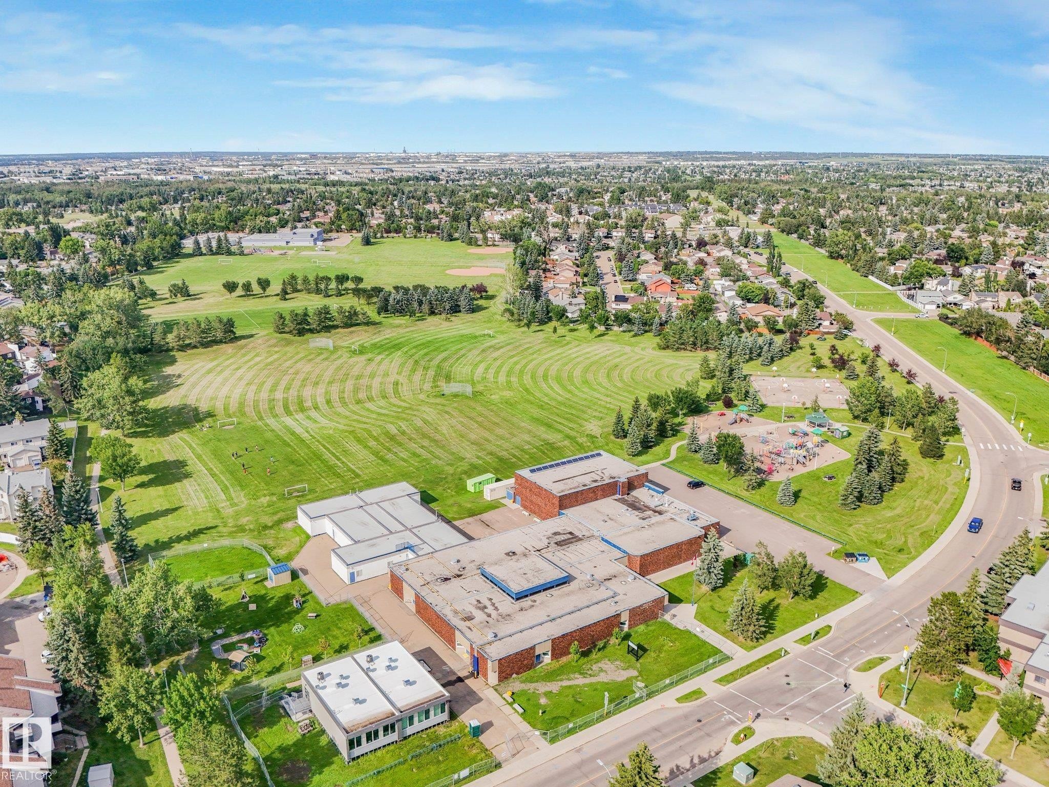 Expansive green spaces featuring manicured lawns and sports fields - #2 3311 58 St Nw, Edmonton, AB - Outdoor With View