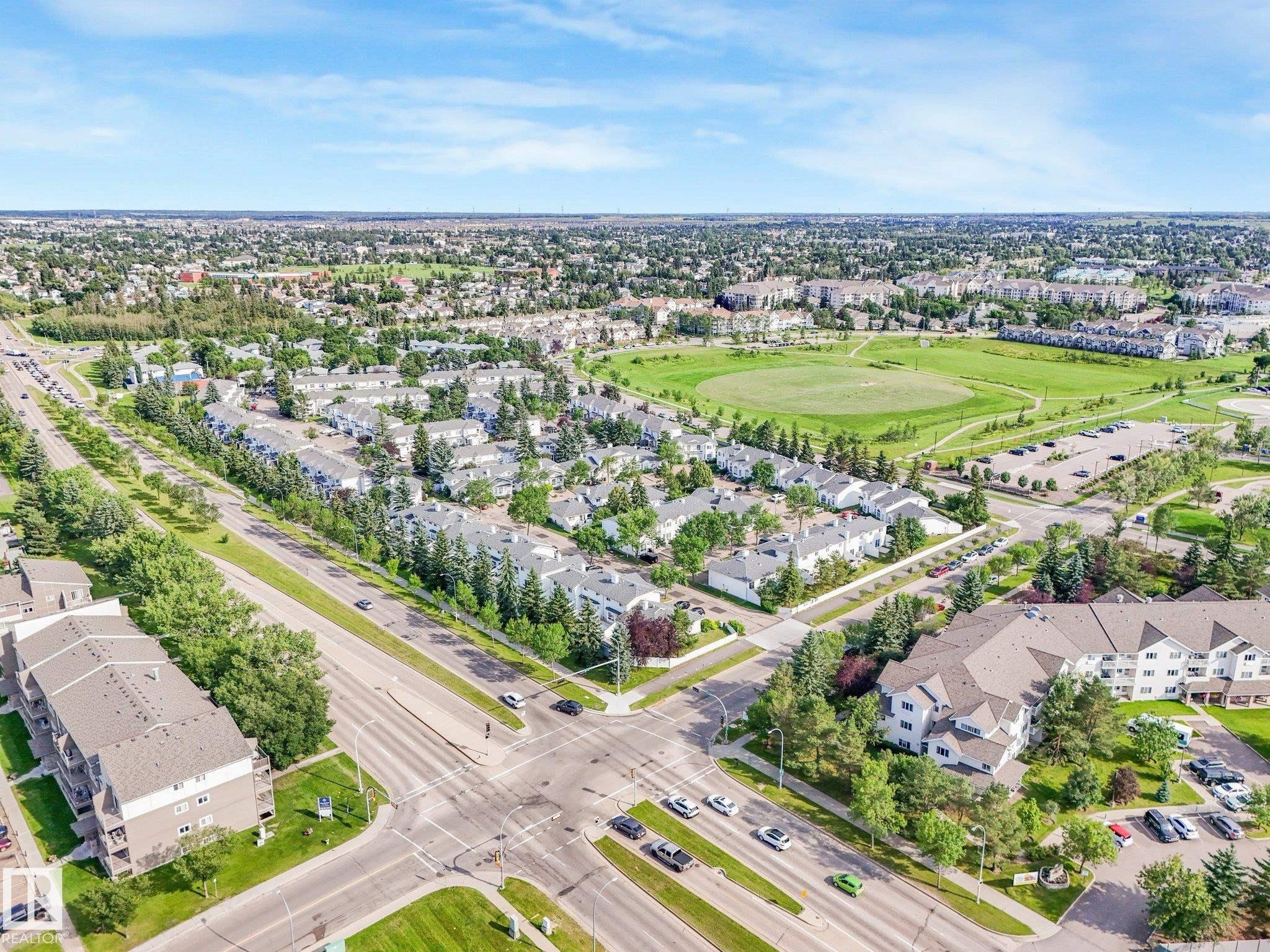 Aerial perspective showcasing a residential area with a diverse mix of housing types - #2 3311 58 St Nw, Edmonton, AB - Outdoor With View