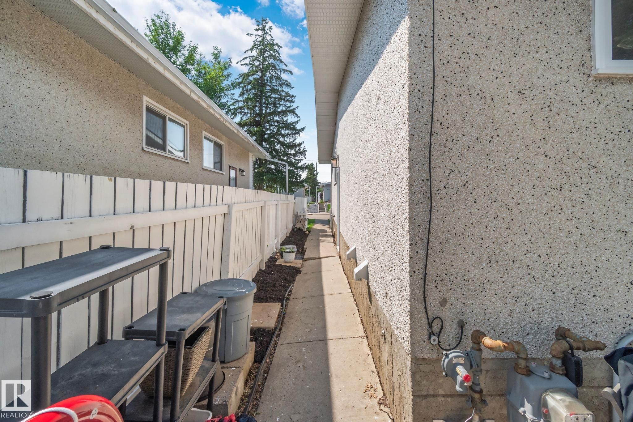 Concrete pathway alongside a home with stucco exterior - 4723 105 Street Nw, Edmonton, AB - Outdoor