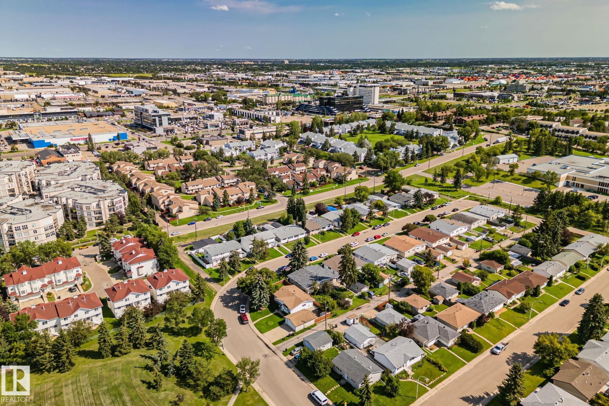 Aerial perspective showcasing a residential neighborhood with a mix of single-family homes and multi-story apartment buildings - 4723 105 Street Nw, Edmonton, AB - Outdoor With View
