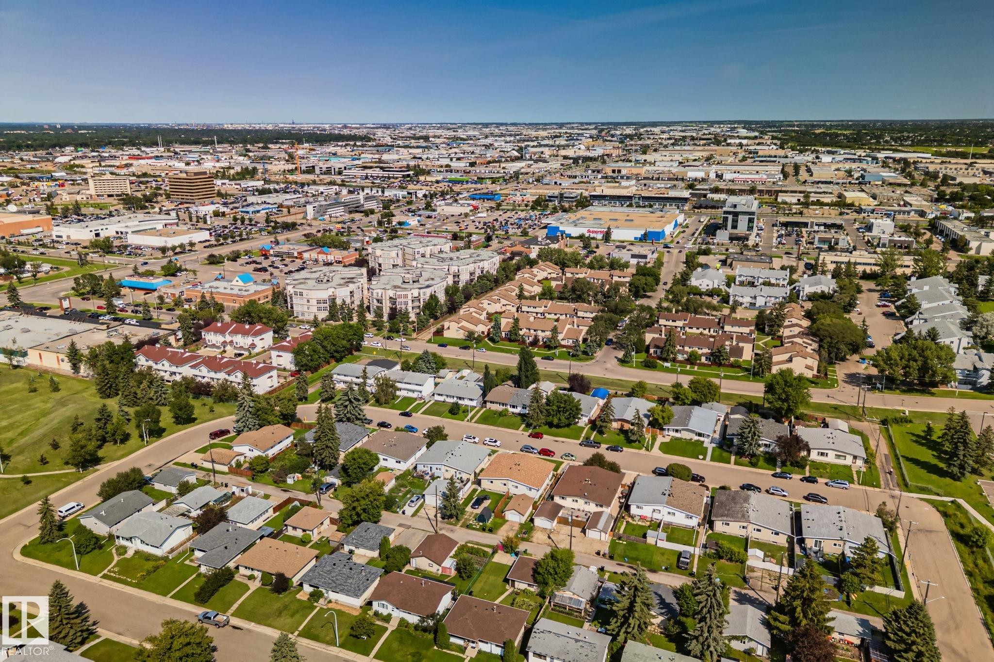 Aerial perspective showcasing a residential neighborhood with single-story and two-story homes, interspersed with green spaces and mature trees - 4723 105 Street Nw, Edmonton, AB - Outdoor With View