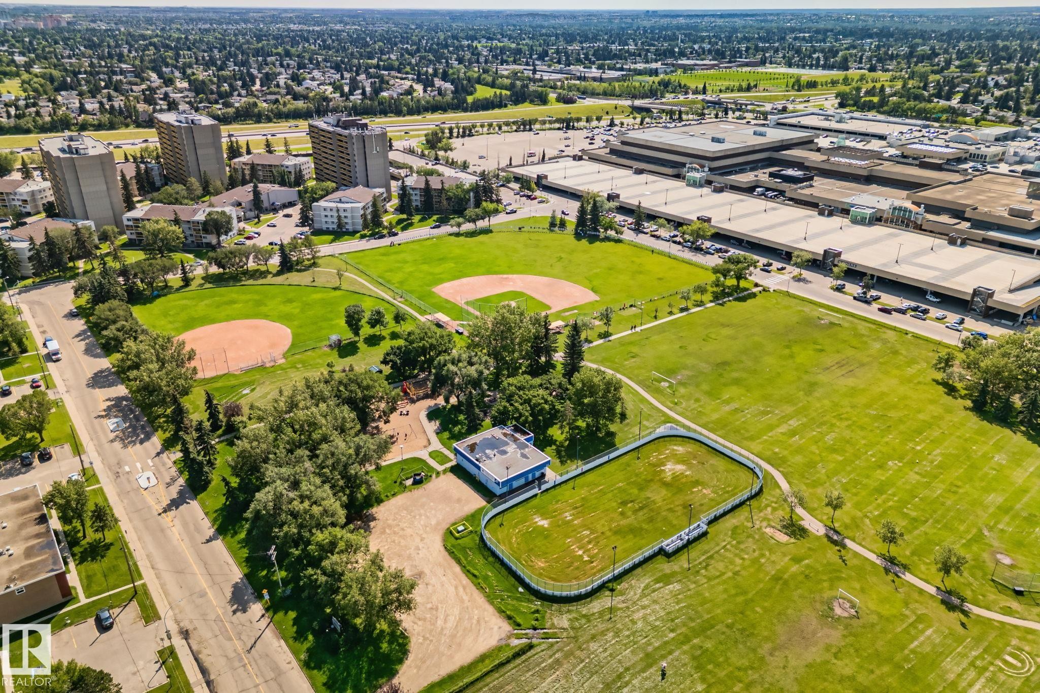 Expansive parkland featuring multiple baseball diamonds, a multi-sport court, walking paths, and mature trees - 4723 105 Street Nw, Edmonton, AB - Outdoor With View