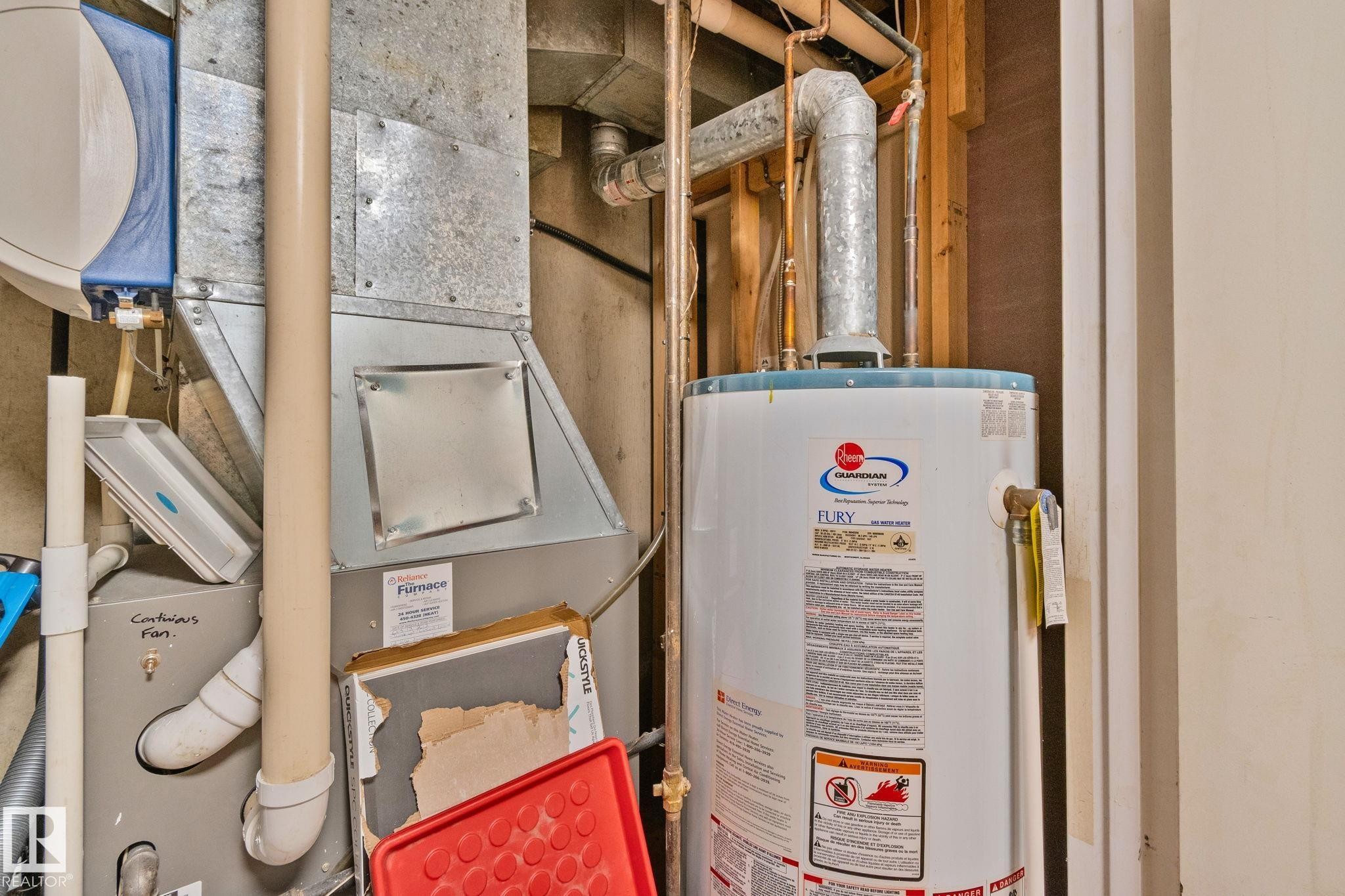Utility area featuring a water heater, furnace, and exposed copper piping - 4723 105 Street Nw, Edmonton, AB - Indoor Photo Showing Basement
