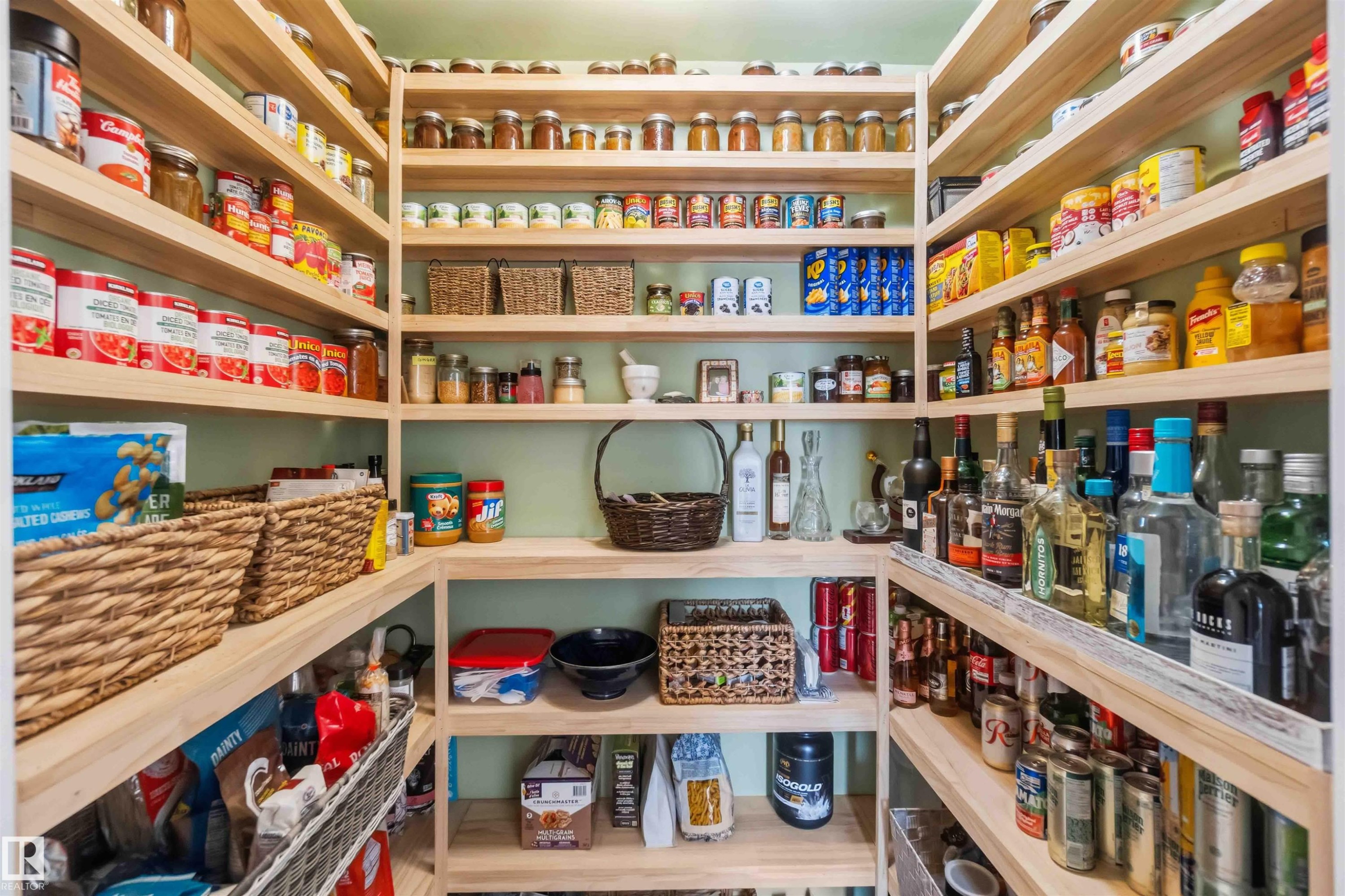 Custom-built pantry featuring extensive wood-finish shelving, providing ample storage - 11351 35A Avenue Nw, Edmonton, AB - Indoor With Storage