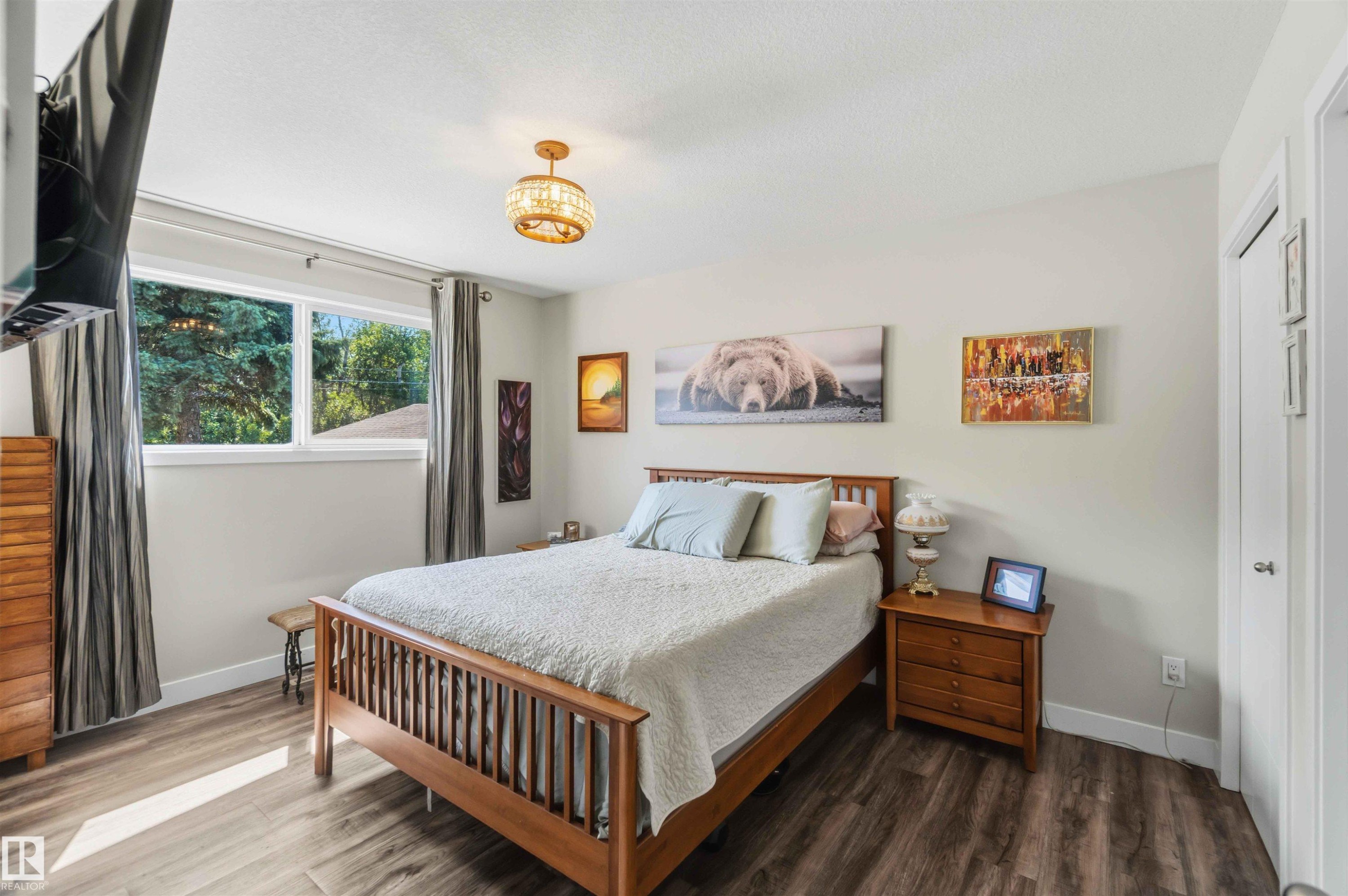Bedroom featuring wood-finish flooring, a double window, a ceiling-mounted light fixture, and a white paneled door - 11351 35A Avenue Nw, Edmonton, AB - Indoor Photo Showing Bedroom
