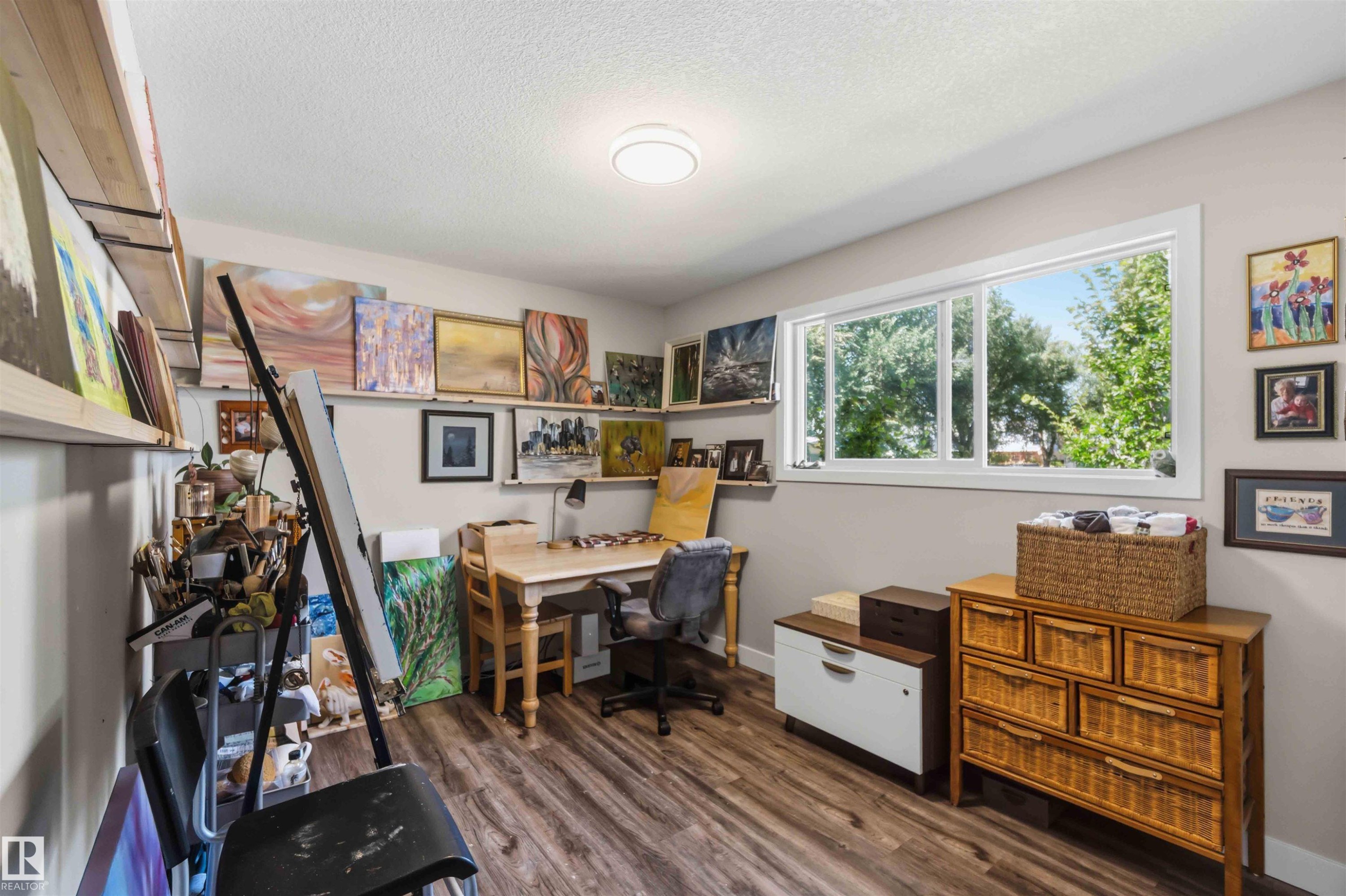Versatile interior space featuring wood-finish flooring, a large window, recessed lighting, and wall-mounted shelving - 11351 35A Avenue Nw, Edmonton, AB - Indoor Photo Showing Office