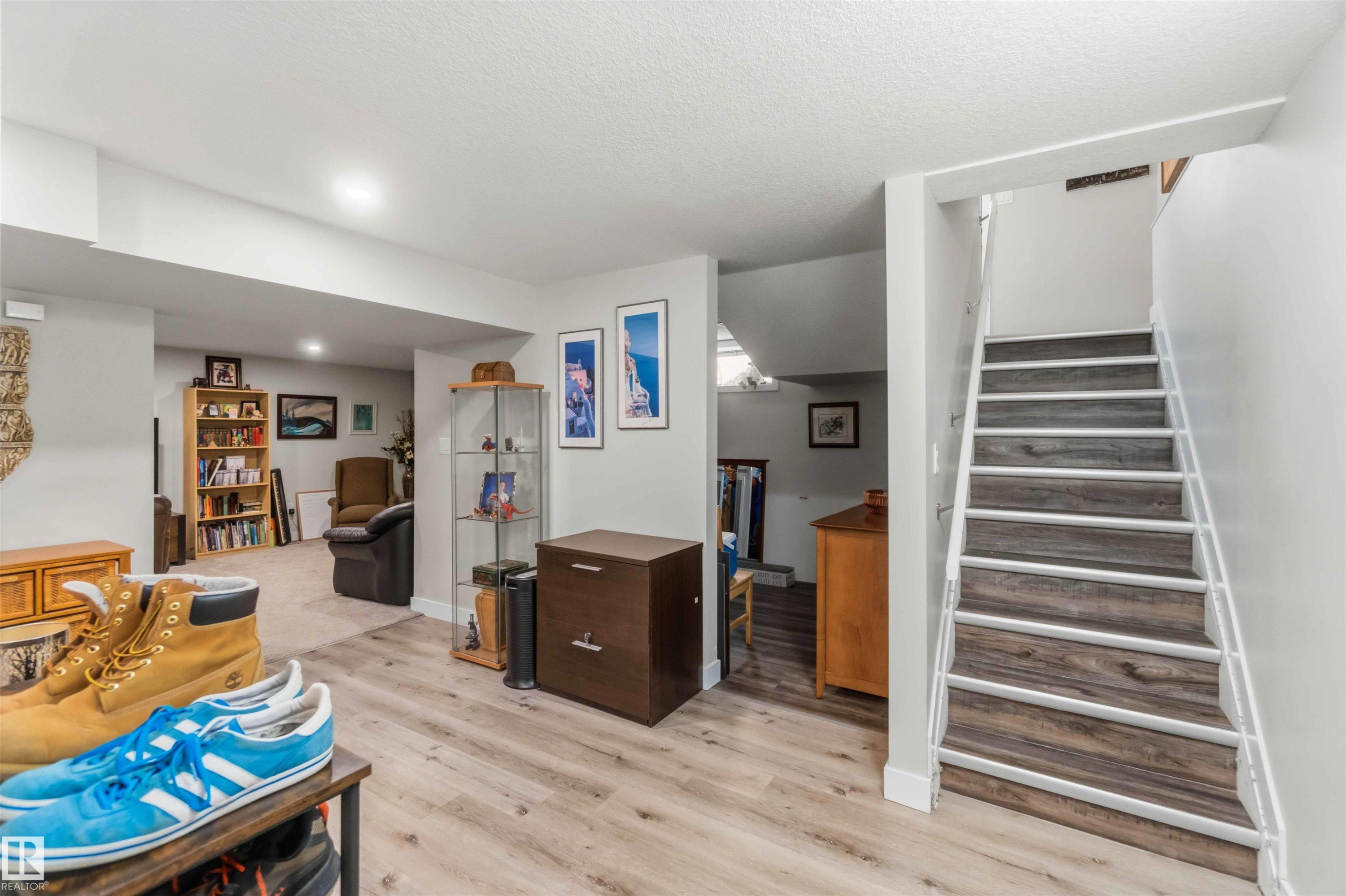 Staircase featuring wood-finish treads with white risers and handrail, recessed lighting, and light-toned walls - 11351 35A Avenue Nw, Edmonton, AB - Indoor Photo Showing Other Room