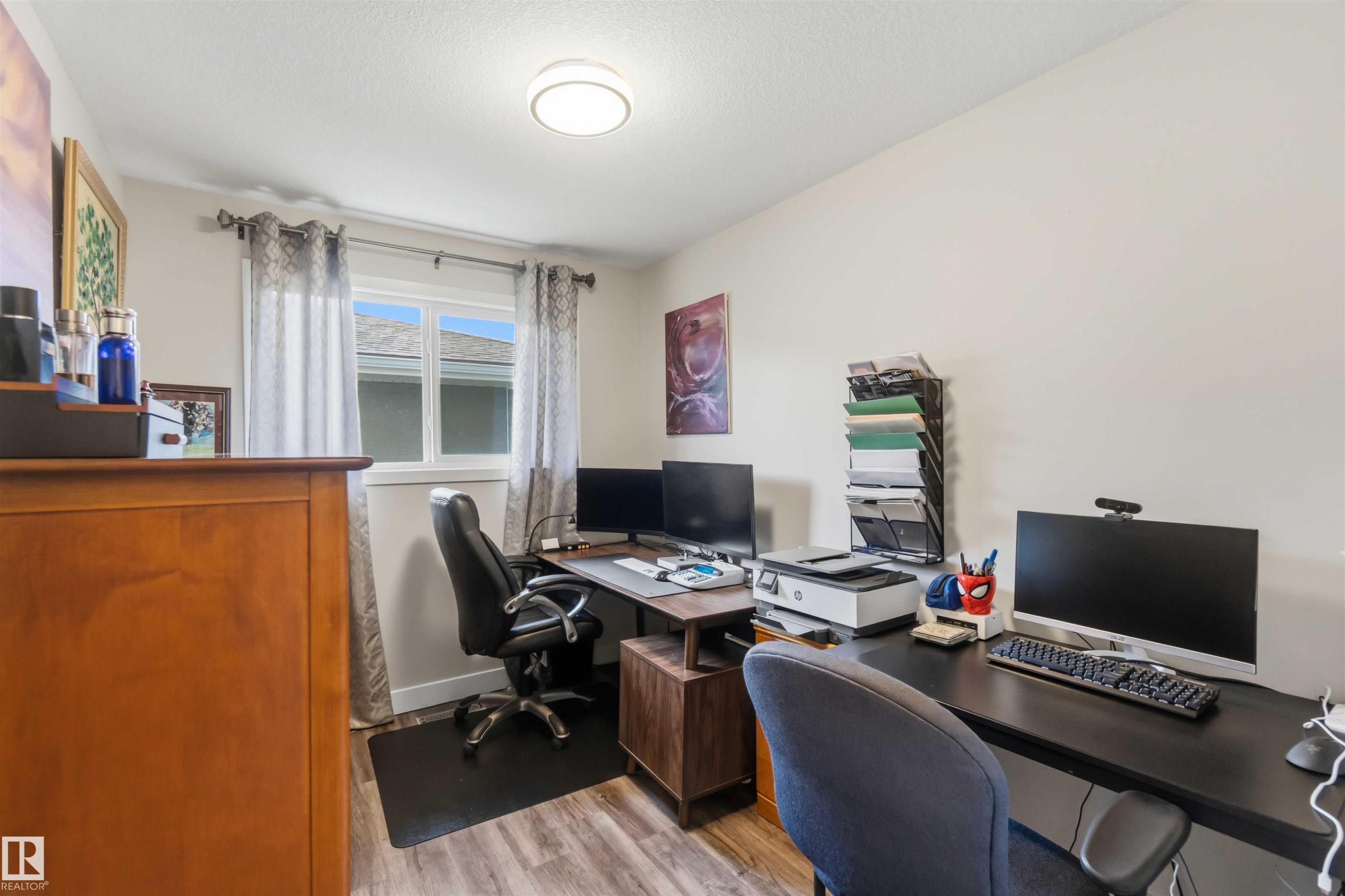 Dedicated workspace featuring wood-finish flooring and a bright window - 11351 35A Avenue Nw, Edmonton, AB - Indoor Photo Showing Office