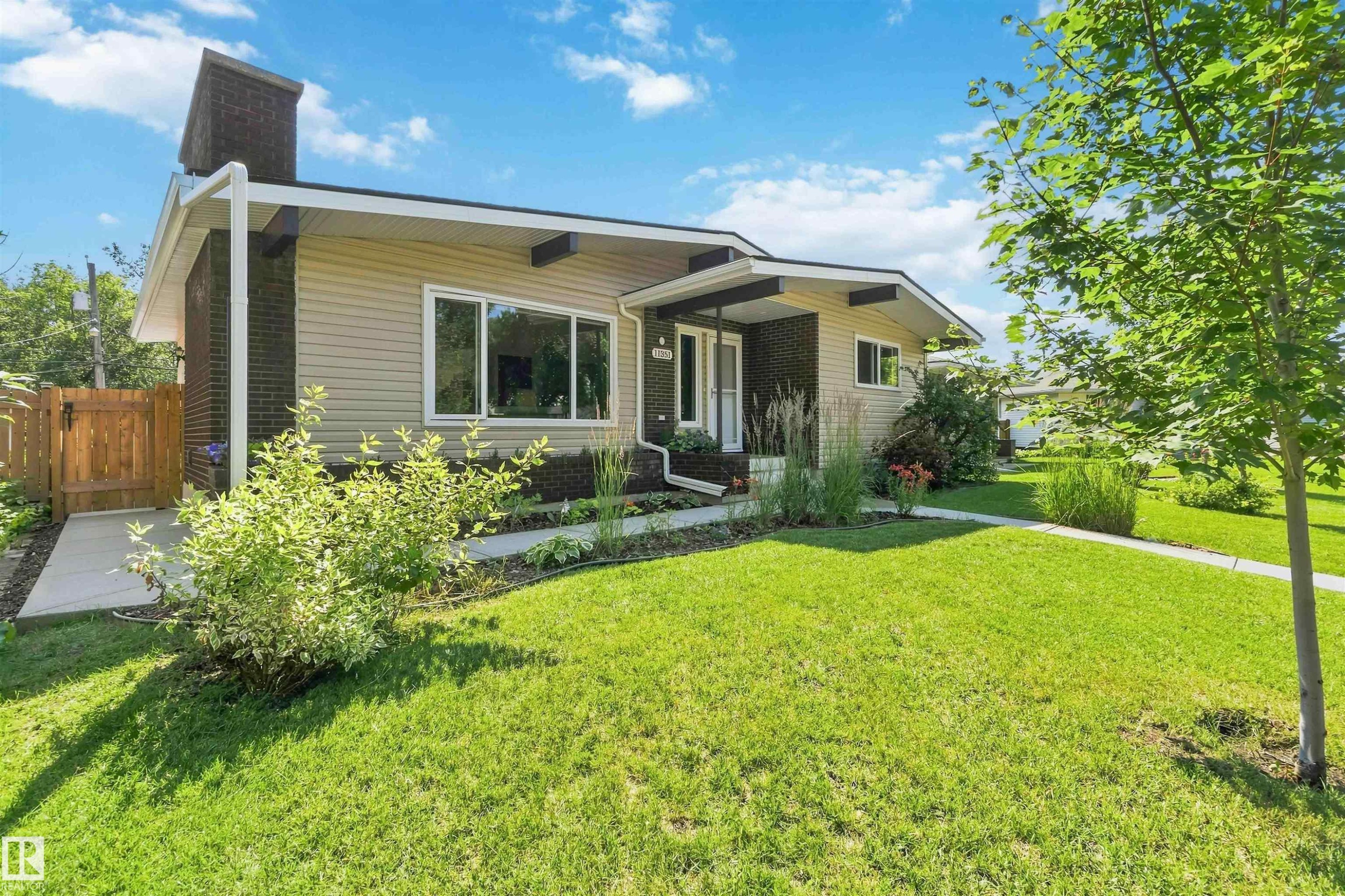 Single-story home featuring light-colored siding and dark brick accents - 11351 35A Avenue Nw, Edmonton, AB - Outdoor
