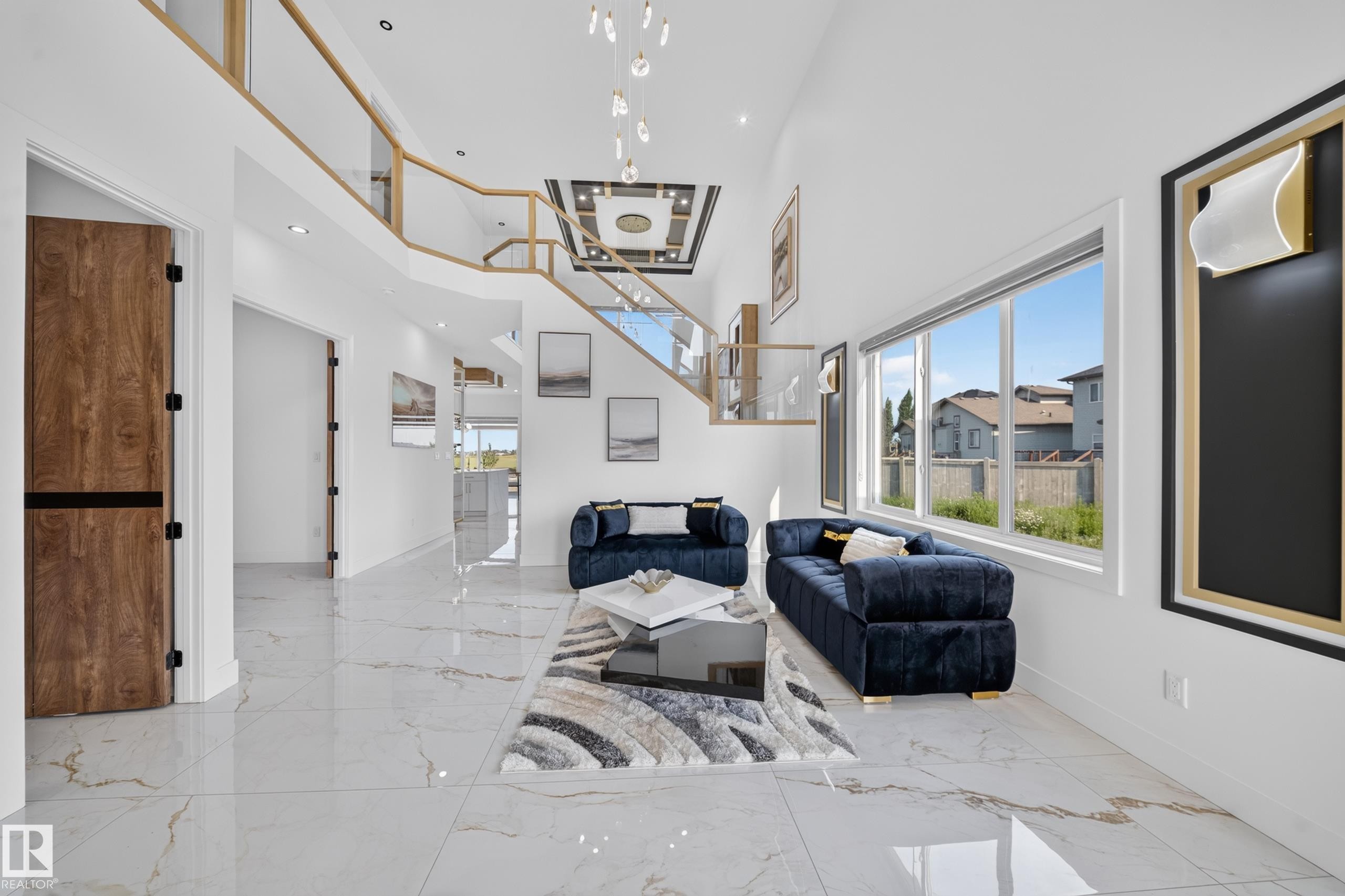 Spacious open-concept interior featuring high ceilings and large windows - 423 Robinson Bv, Leduc, AB - Indoor Photo Showing Other Room