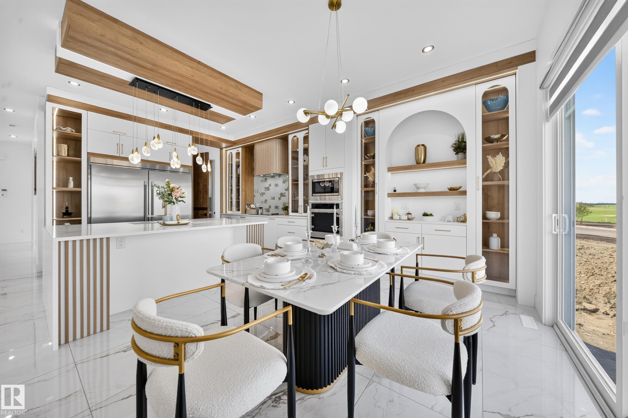 Open-concept kitchen and dining area featuring a marble-finish dining table, gold-accented seating, and white cabinetry - 423 Robinson Bv, Leduc, AB - Indoor Photo Showing Dining Room