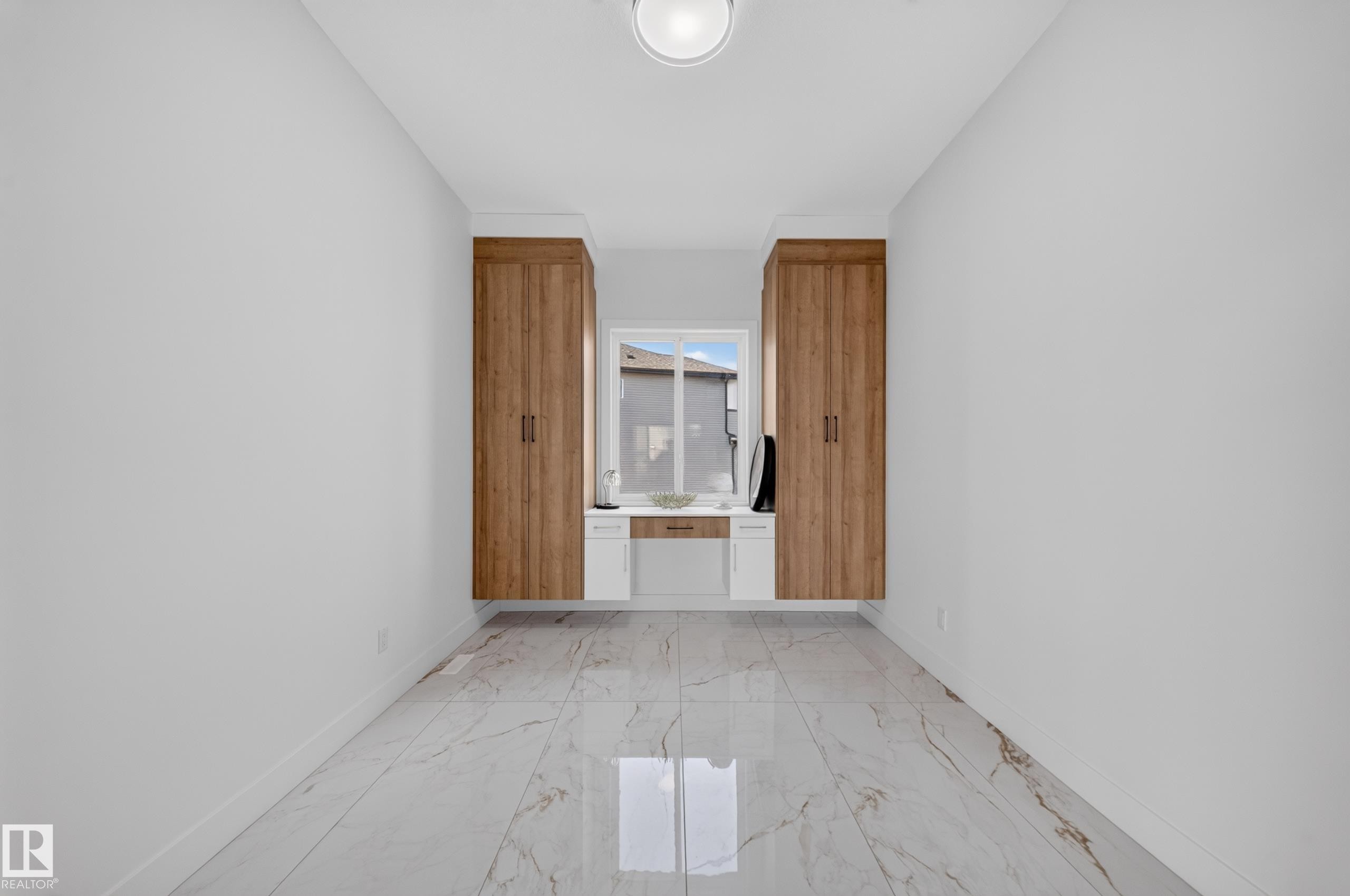 Bright room featuring light-toned walls and large format marble-look tile flooring - 423 Robinson Bv, Leduc, AB - Indoor Photo Showing Other Room