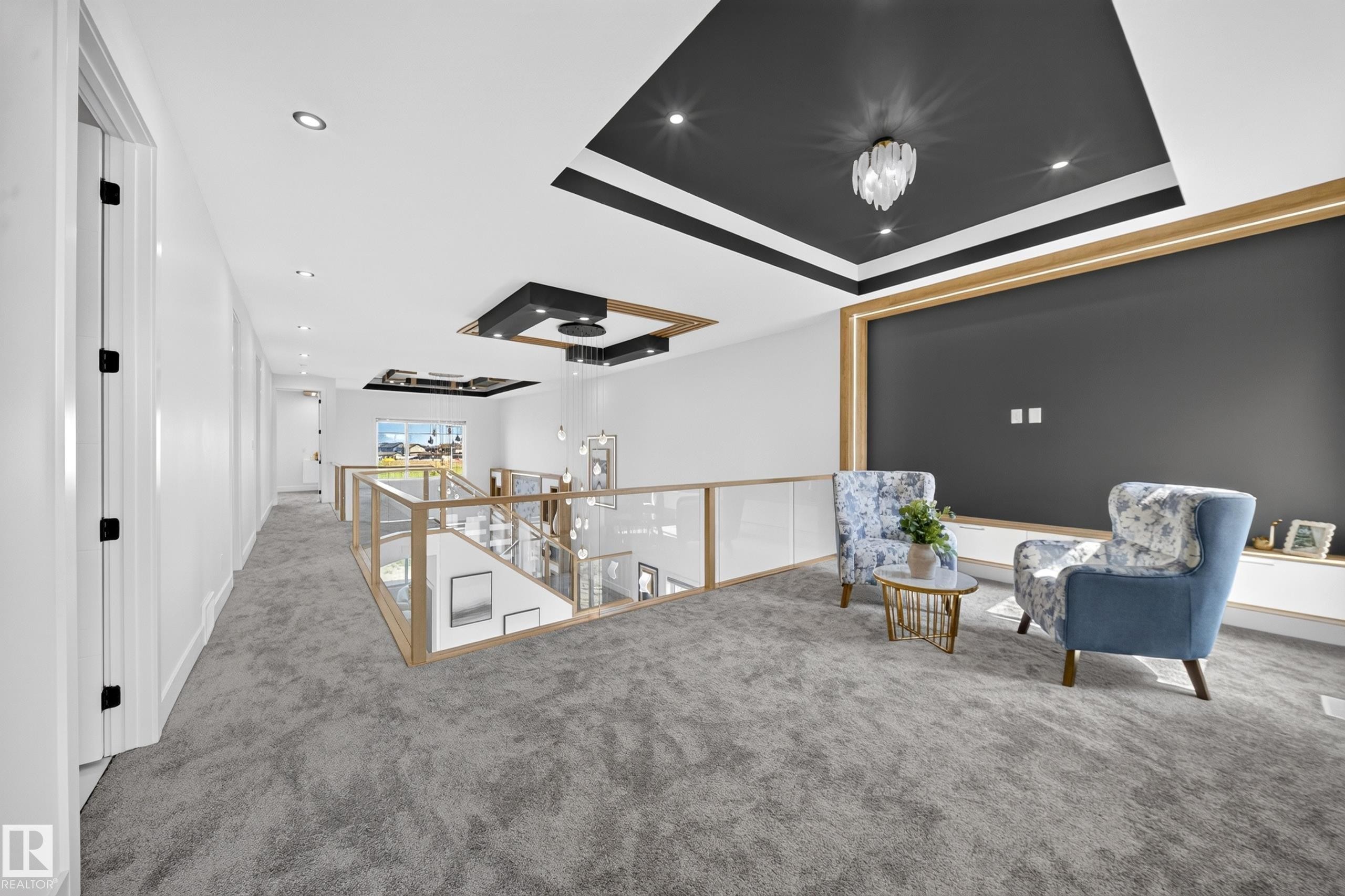 Open-concept upper-level landing featuring a wood-frame and glass railing, recessed lighting, and a custom ceiling design with a contemporary chandelier - 423 Robinson Bv, Leduc, AB - Indoor Photo Showing Other Room