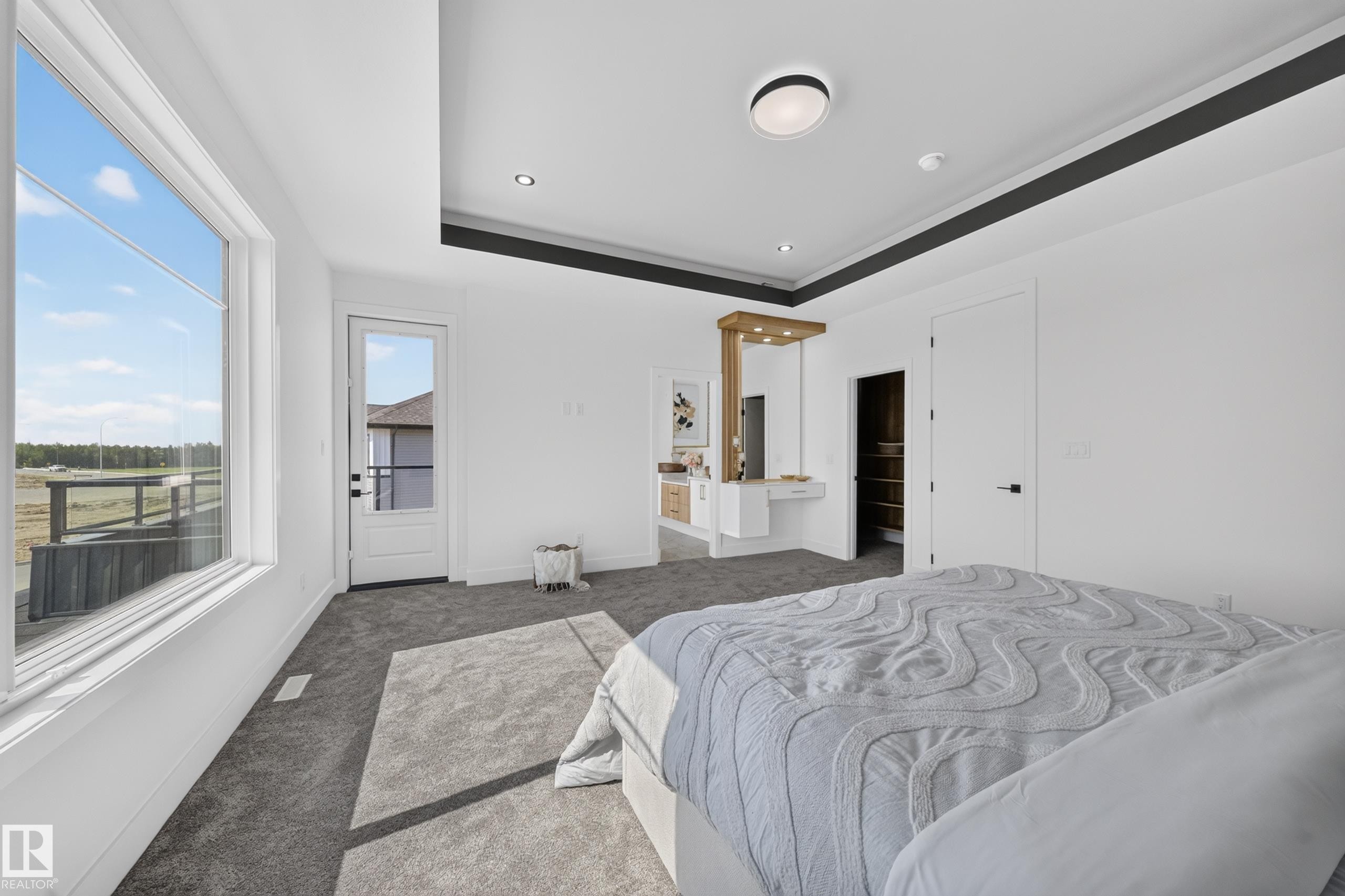 Spacious room featuring a large window, a glass-paneled exterior door, and recessed lighting - 423 Robinson Bv, Leduc, AB - Indoor Photo Showing Bedroom