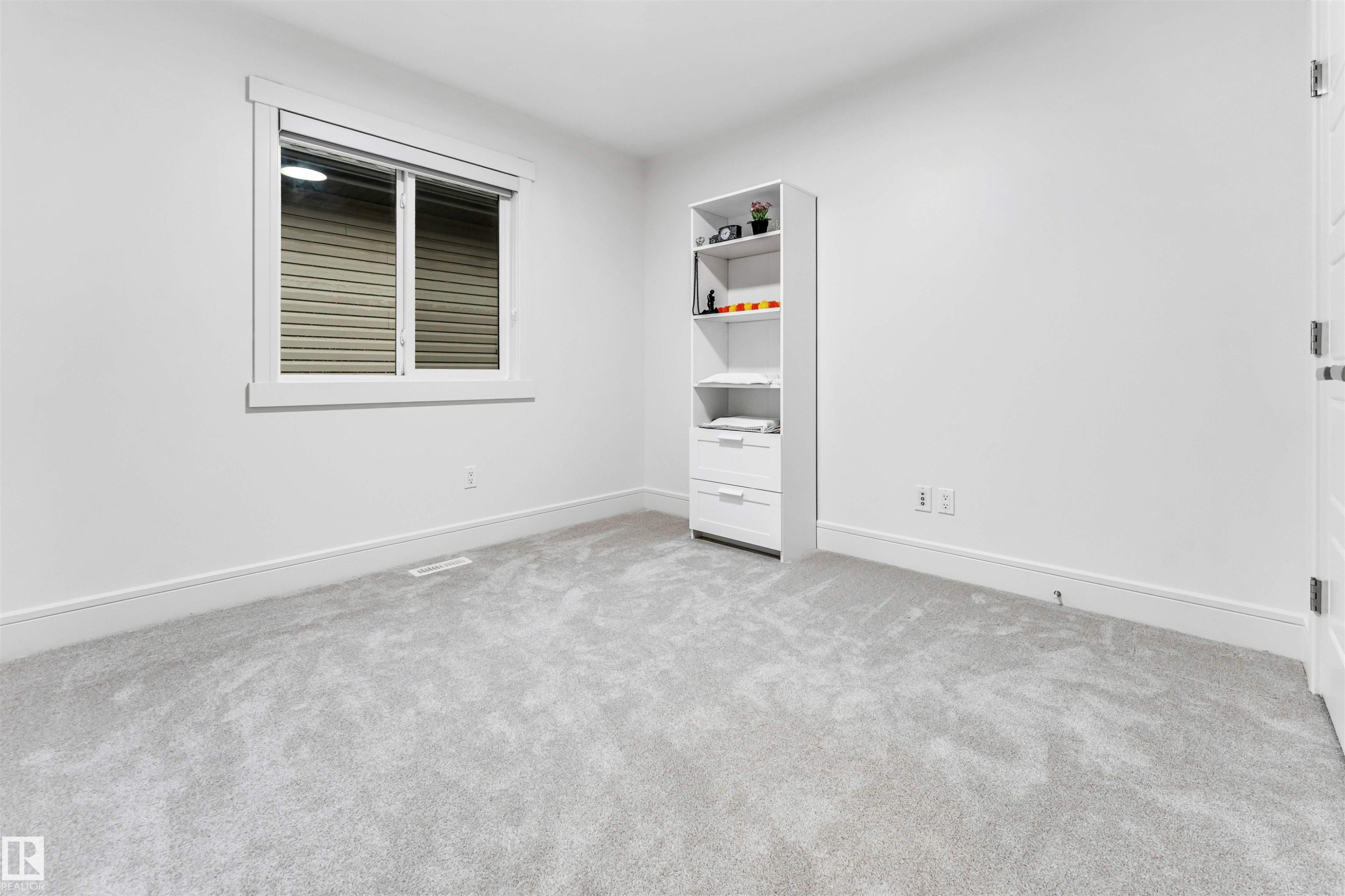 Neutral-toned carpeting paired with crisp white walls - 6727 20 Ave Sw, Edmonton, AB - Indoor