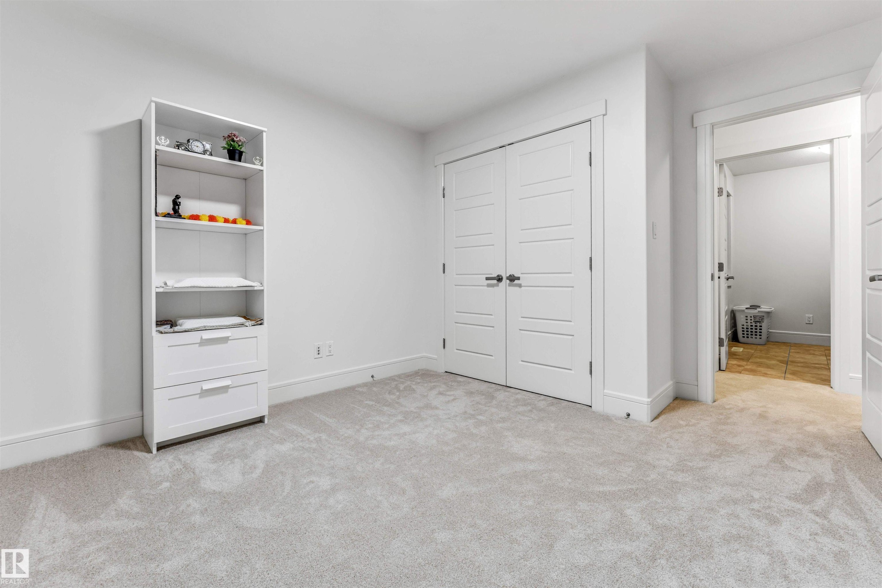 Wall-to-wall light gray carpeting, white baseboards, and bright white walls define this interior space - 6727 20 Ave Sw, Edmonton, AB - Indoor