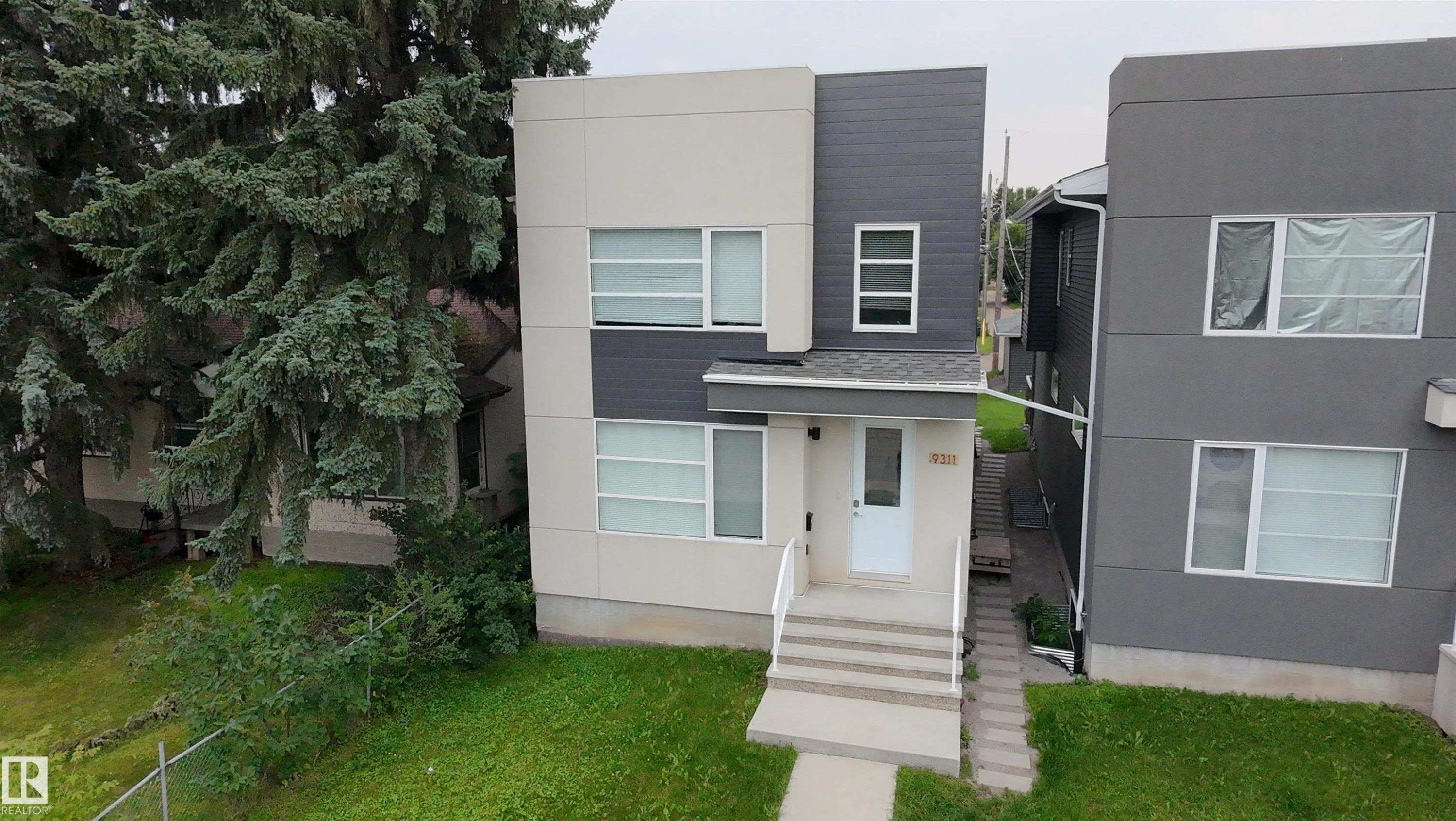 Contemporary facade featuring light and dark gray siding - 9311 66 Avenue Nw, Edmonton, AB - Outdoor
