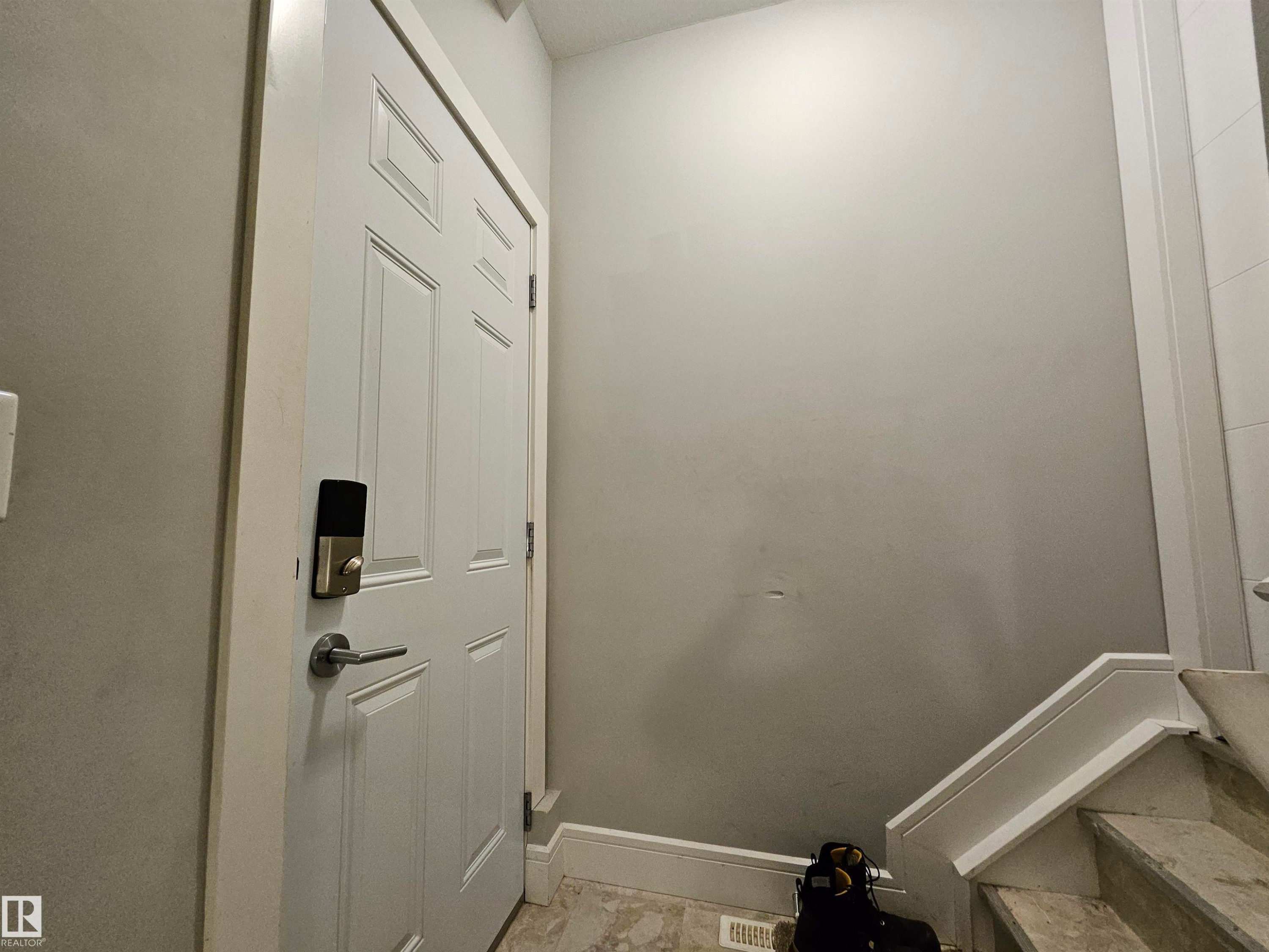 Panel door with smart lock hardware - 9311 66 Avenue Nw, Edmonton, AB - Indoor Photo Showing Other Room