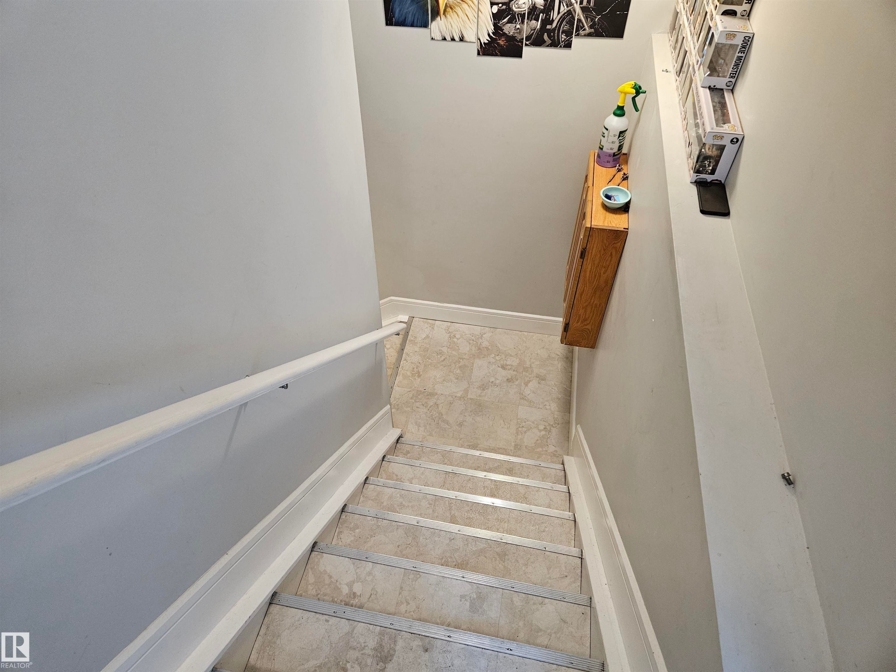 Interior staircase with light grey walls, white baseboards, and a white handrail - 9311 66 Avenue Nw, Edmonton, AB - Indoor Photo Showing Other Room
