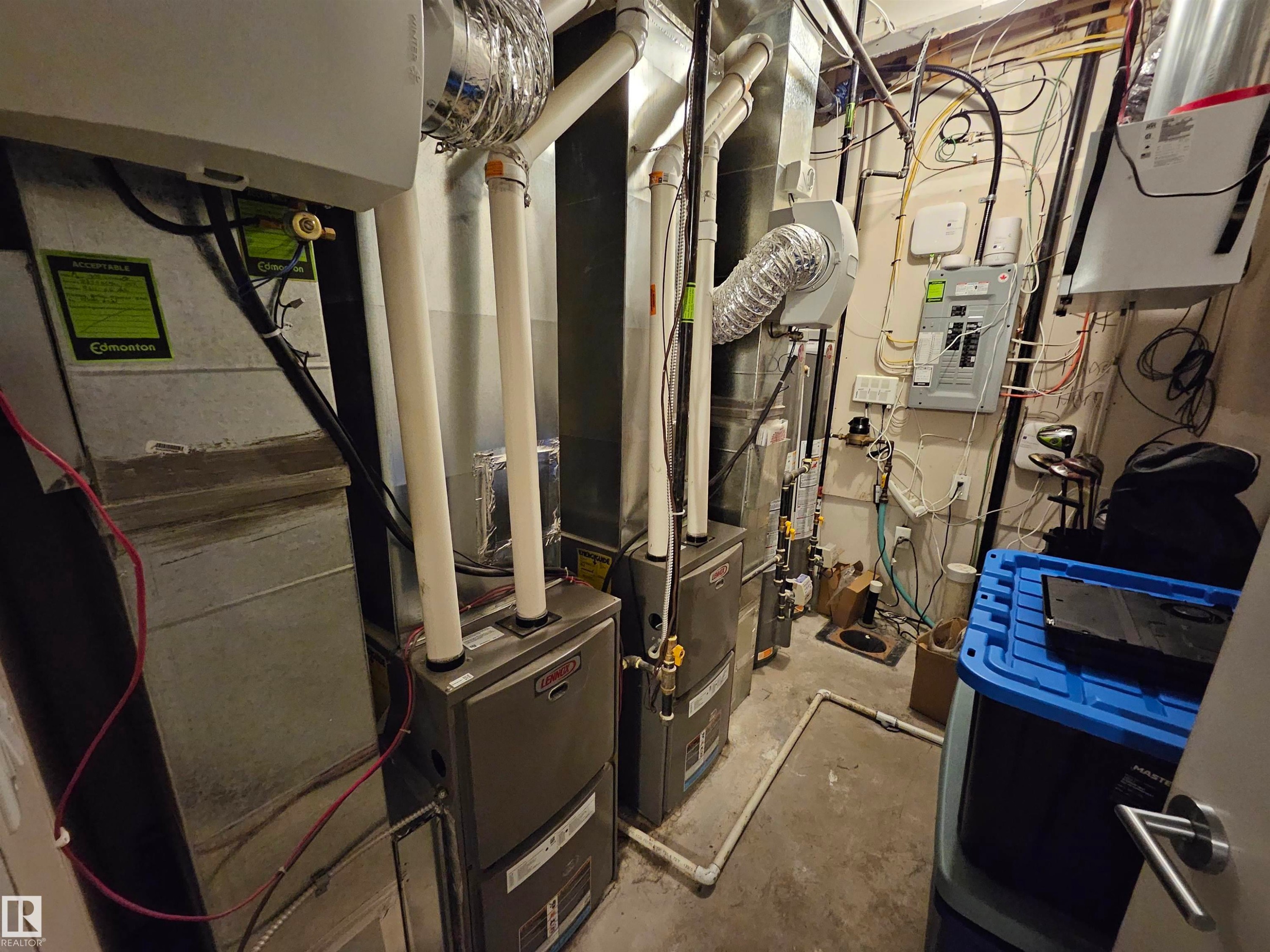 Dual furnaces and associated ductwork, electrical panel, and utility connections - 9311 66 Avenue Nw, Edmonton, AB - Indoor Photo Showing Basement