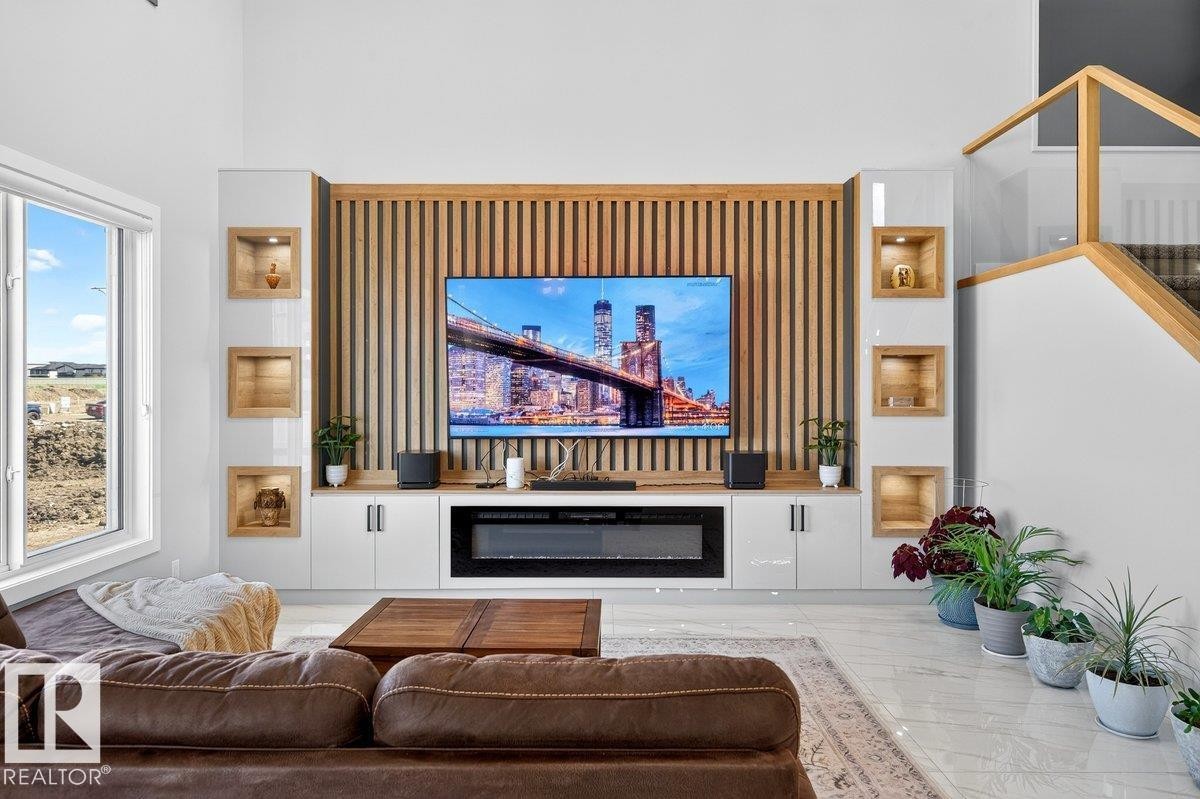 Integrated media wall featuring a wood slat accent, built-in electric fireplace, and recessed display niches - 6001 19 Street, Nisku, AB - Indoor Photo Showing Living Room