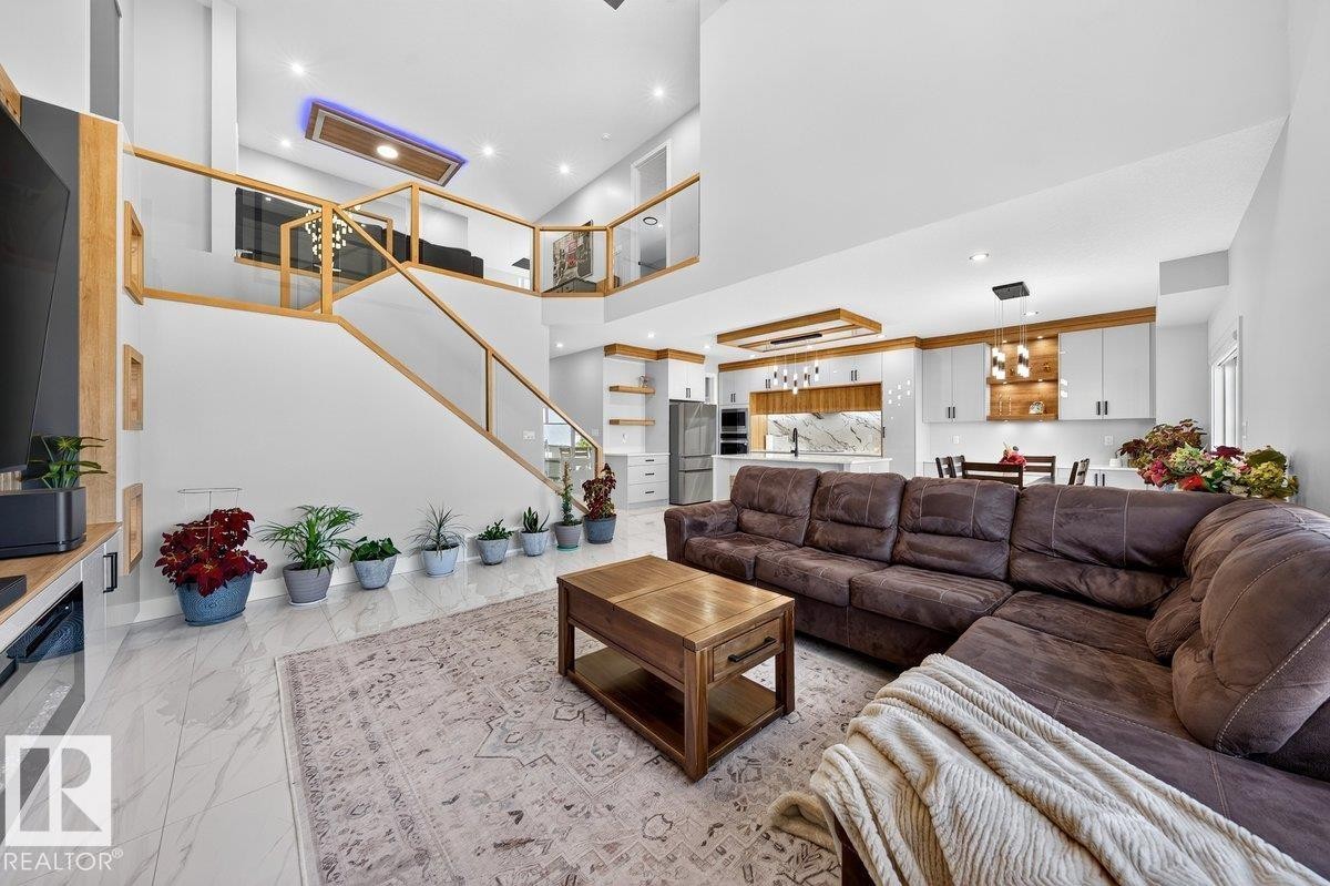 Open-concept living area with high ceilings and wood-finish accents - 6001 19 Street, Nisku, AB - Indoor Photo Showing Living Room