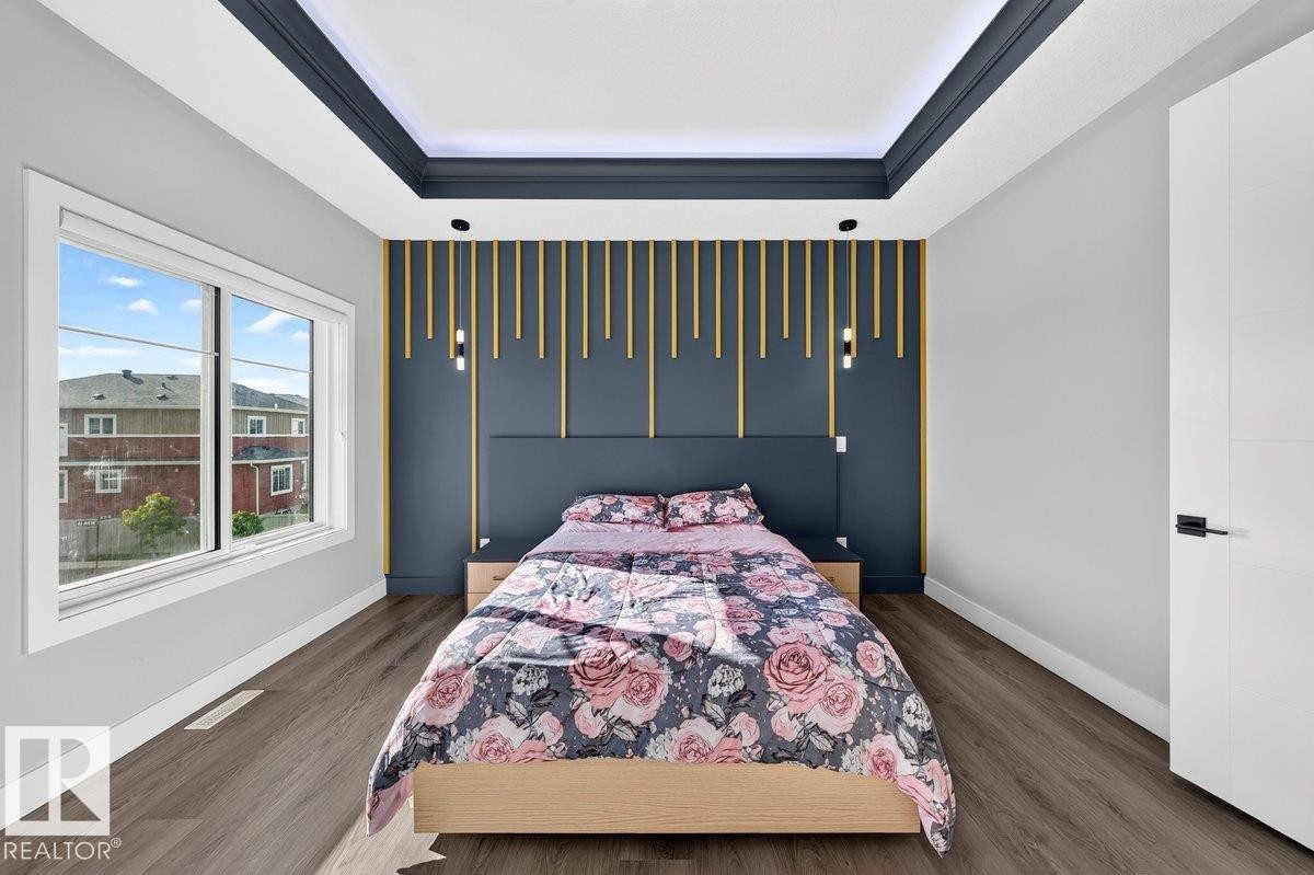 Accent wall featuring vertical decorative slats and integrated sconce lighting - 6001 19 Street, Nisku, AB - Indoor Photo Showing Bedroom