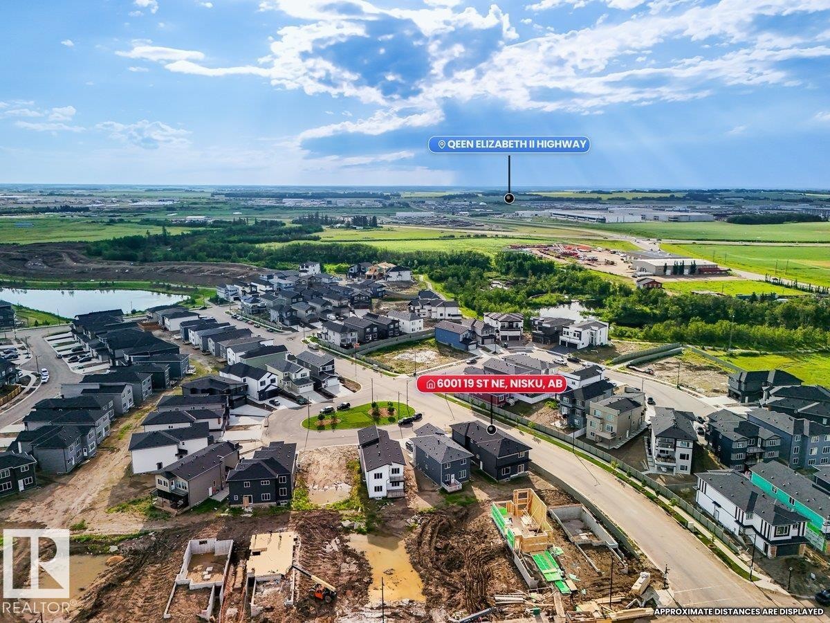 Aerial view showcasing a developing residential area with numerous modern homes - 6001 19 Street, Nisku, AB - Outdoor With View