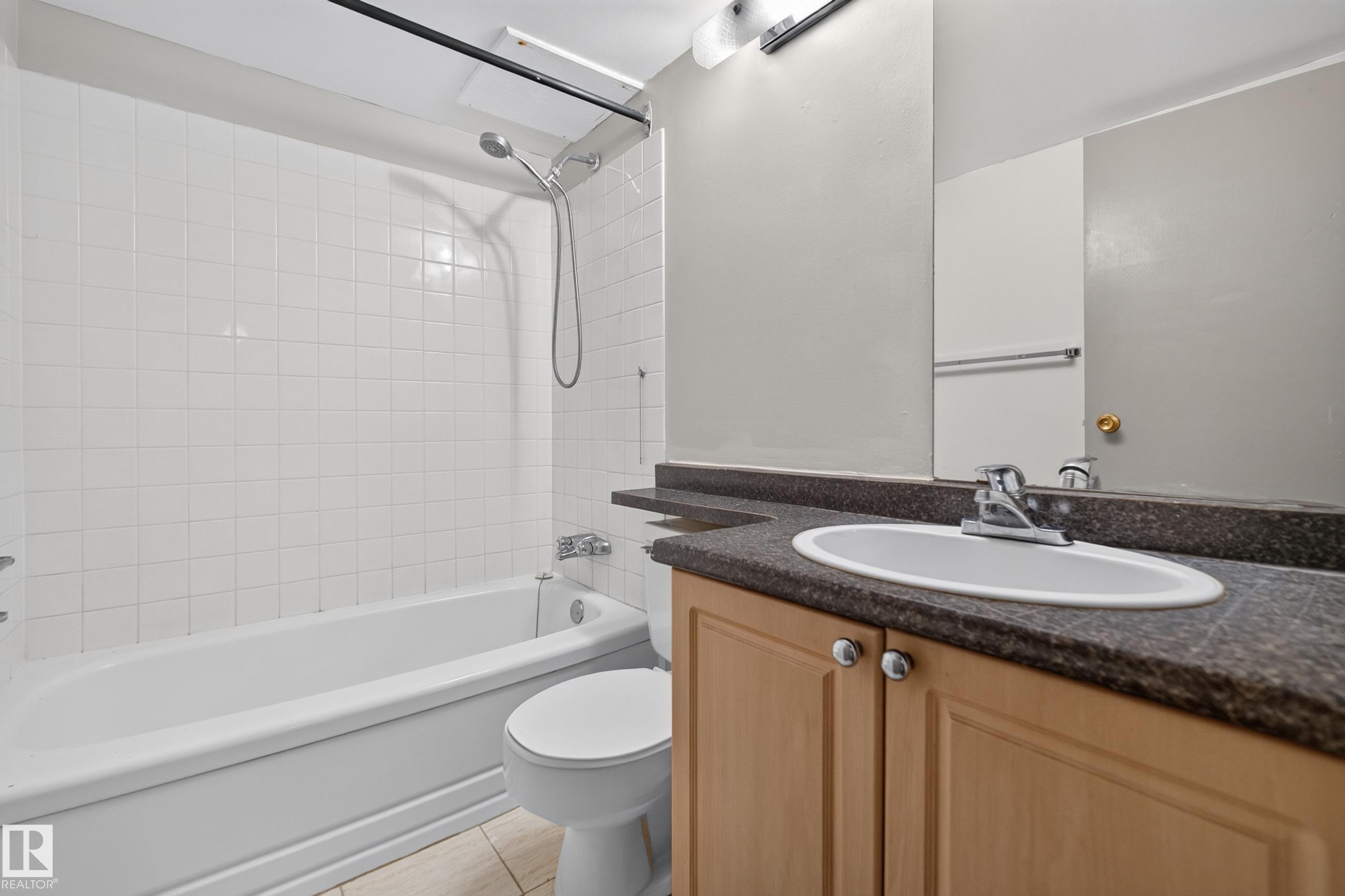 Bathroom featuring a tub/shower combination with white subway tile surround - #1508 10883 Saskatchewan Dr Nw Nw, Edmonton, AB - Indoor Photo Showing Bathroom