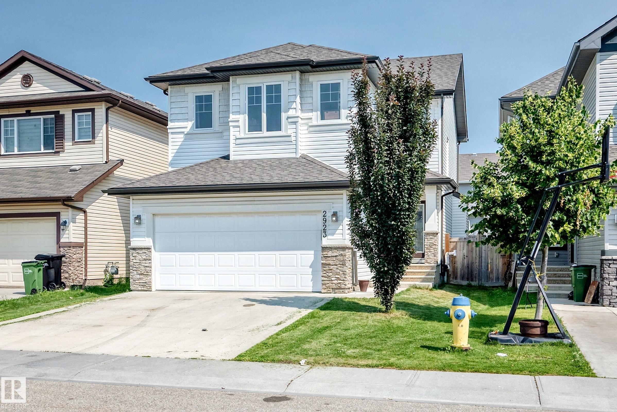 Two-story residence featuring light-colored horizontal siding and stone veneer accents - 2923 16 Street Nw, Edmonton, AB - Outdoor With Facade