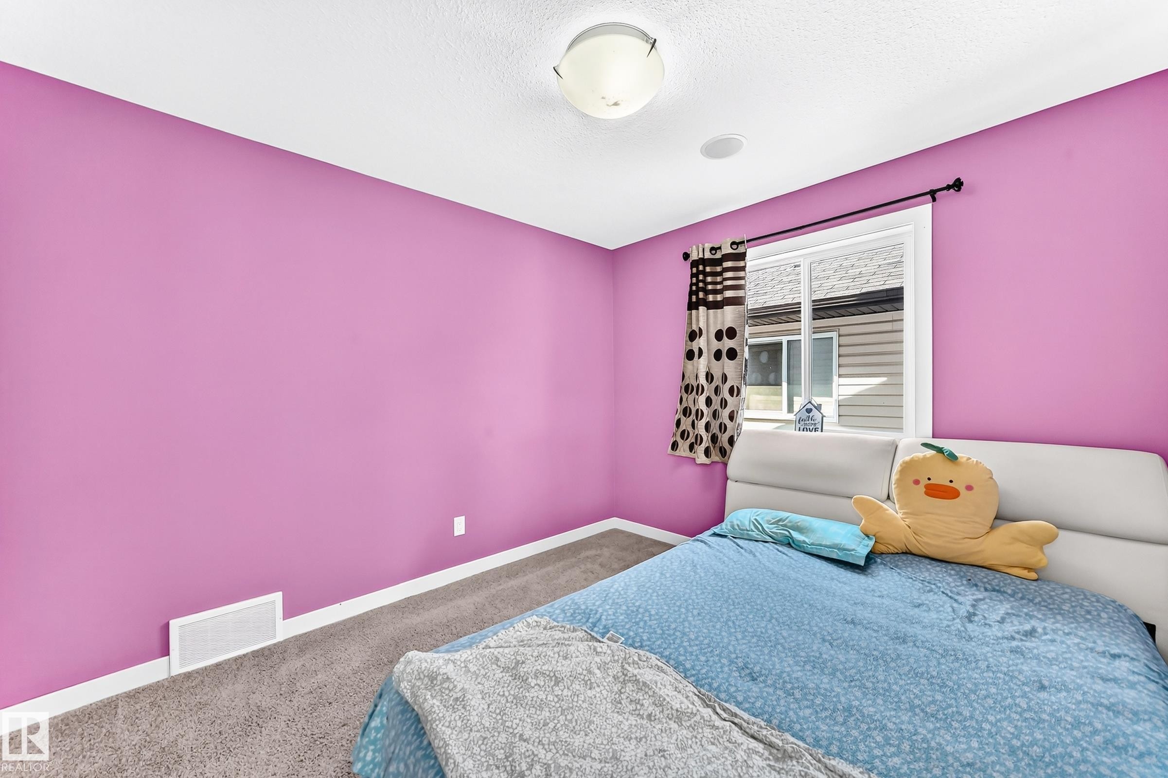 Bedroom featuring vibrant magenta walls and gray carpet flooring - 2923 16 Street Nw, Edmonton, AB - Indoor Photo Showing Bedroom