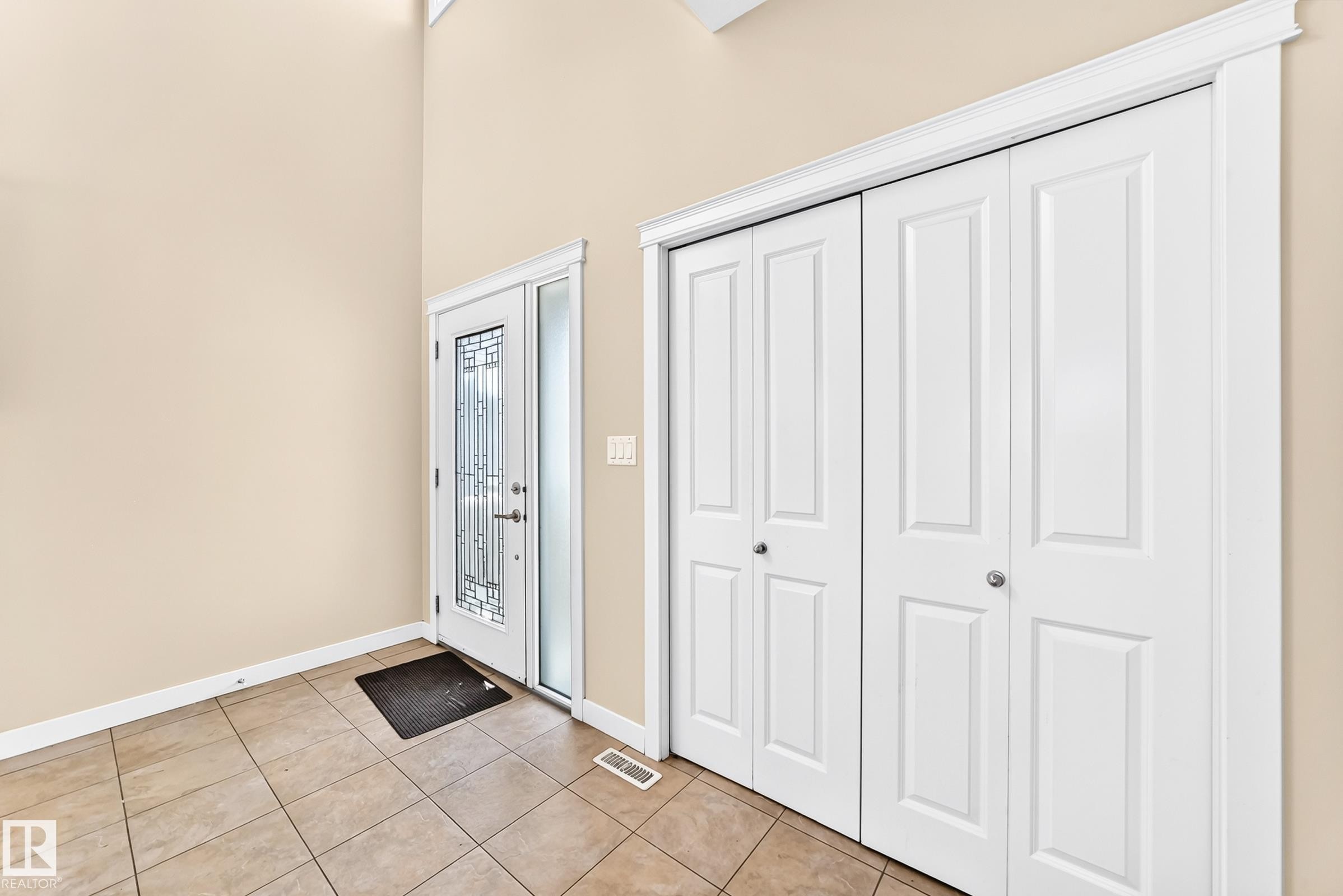 Entryway featuring a decorative glass front door, transom window, and sidelight - 2923 16 Street Nw, Edmonton, AB - Indoor Photo Showing Other Room