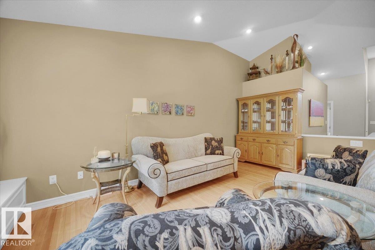 Spacious living area featuring vaulted ceilings, recessed lighting, and wood-finish flooring - 928 Thompson Place Nw, Edmonton, AB - Indoor Photo Showing Living Room
