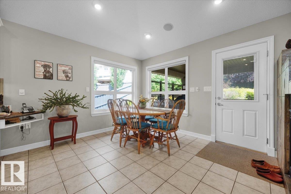 Bright dining space featuring tile flooring, recessed lighting, and two large windows - 928 Thompson Place Nw, Edmonton, AB - Indoor Photo Showing Dining Room