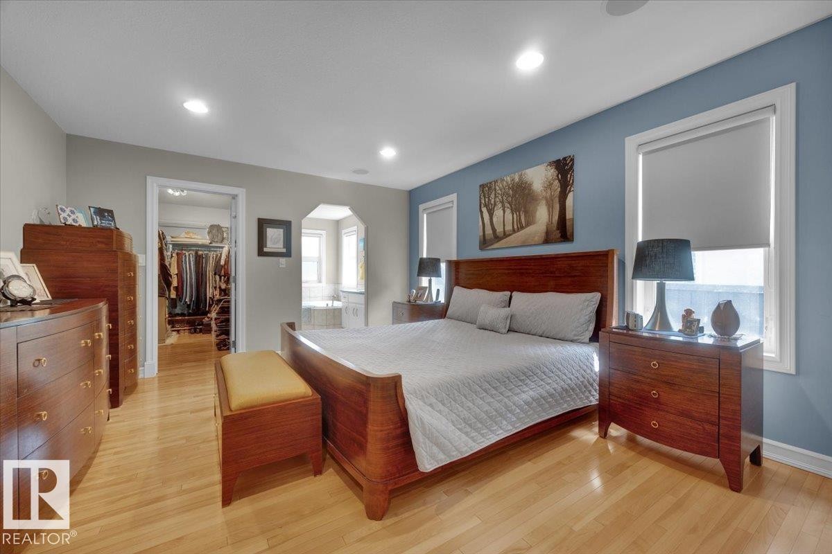 Hardwood flooring throughout the room, recessed lighting, and white trim - 928 Thompson Place Nw, Edmonton, AB - Indoor Photo Showing Bedroom