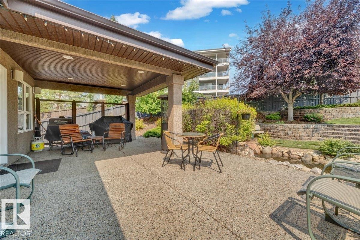 Covered patio with an exposed aggregate concrete surface - 928 Thompson Place Nw, Edmonton, AB - Outdoor With Deck Patio Veranda