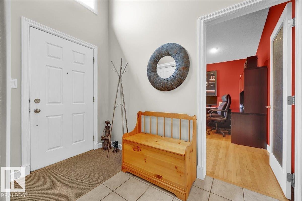 Inviting entry foyer featuring a white paneled front door, ceramic tile flooring, and a transom window above - 928 Thompson Place Nw, Edmonton, AB - Indoor Photo Showing Other Room
