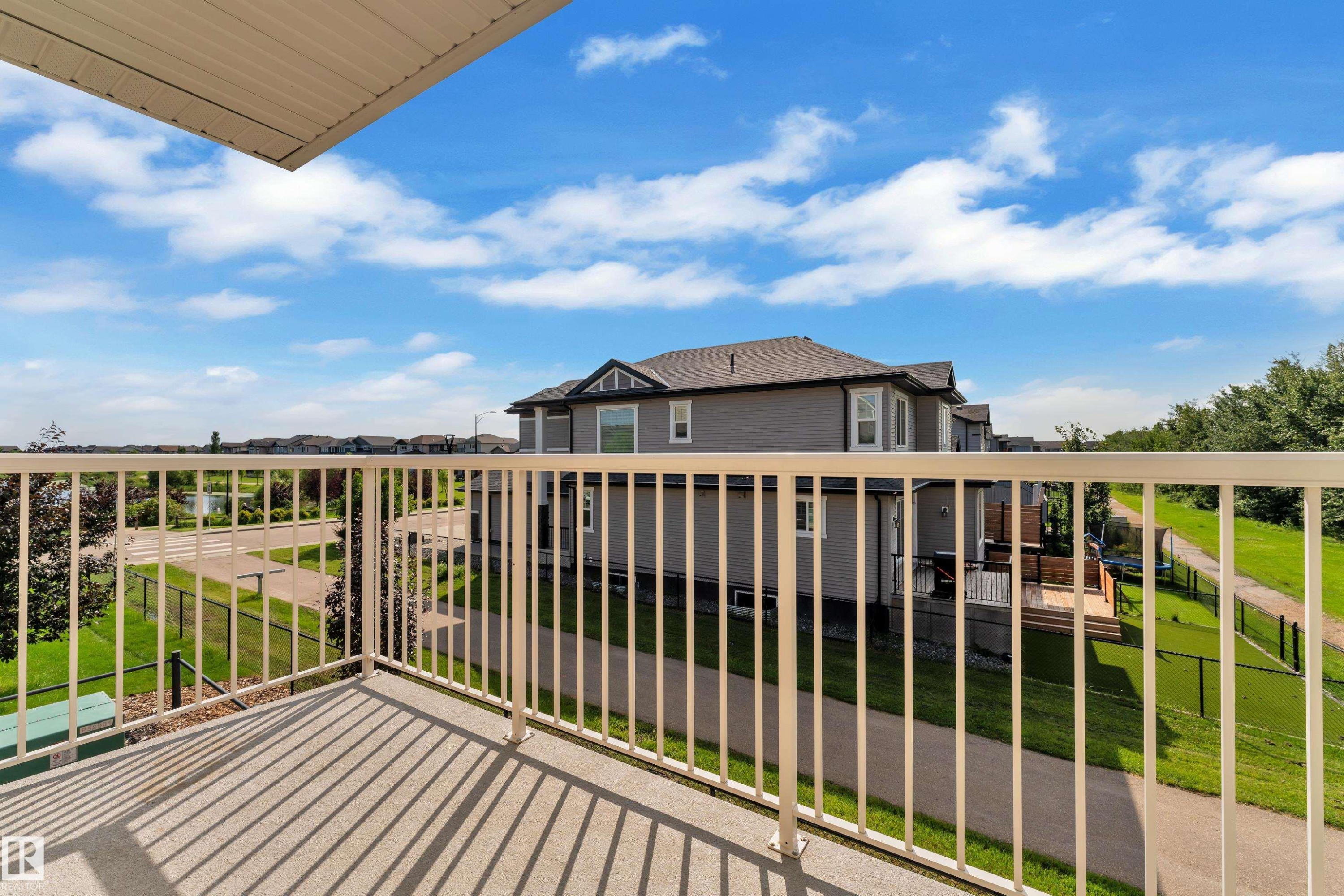 Balcony with concrete flooring and white metal railing - #64 17832 78 St Nw Nw, Edmonton, AB - Outdoor With Balcony With Exterior